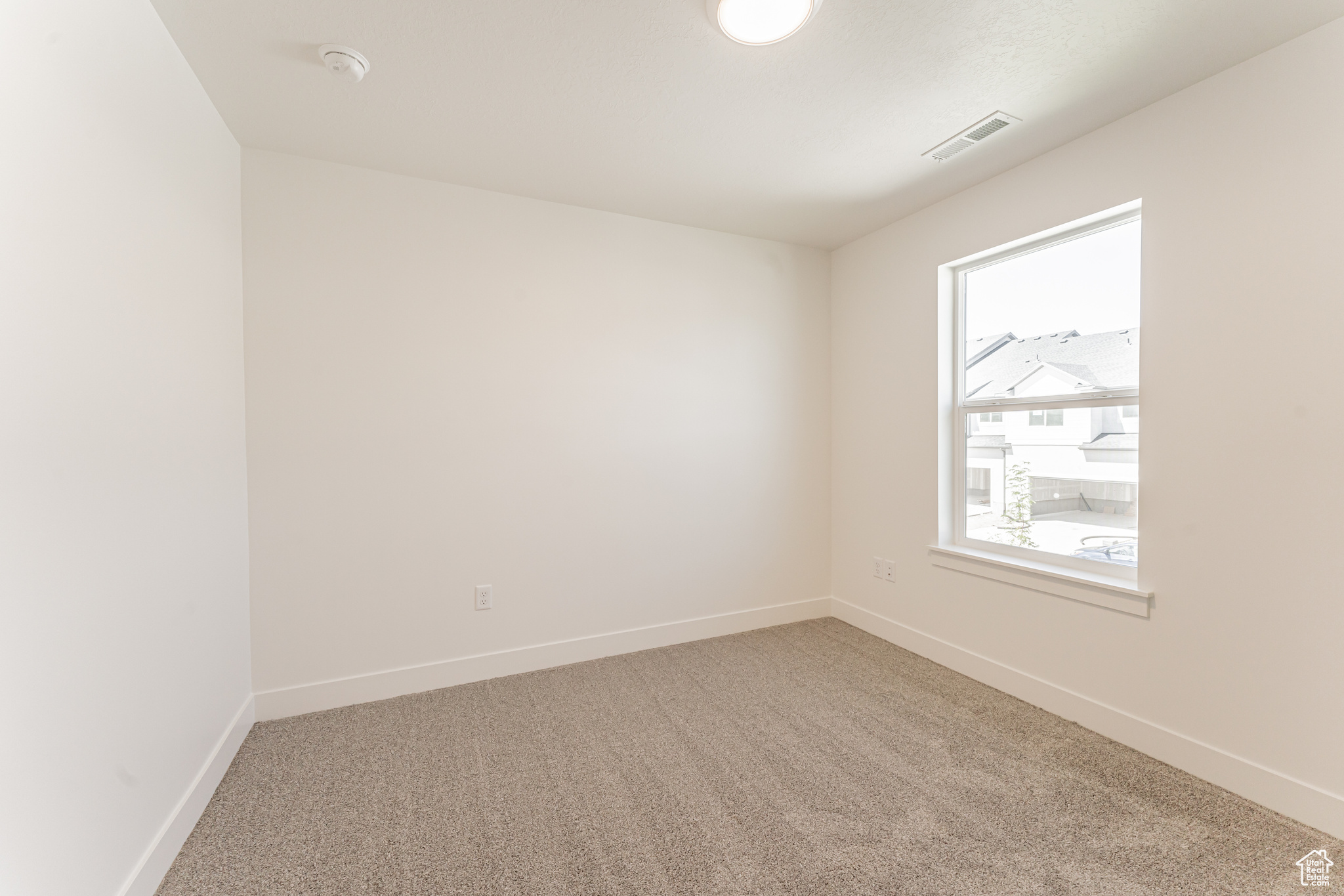 Unfurnished room with light carpet