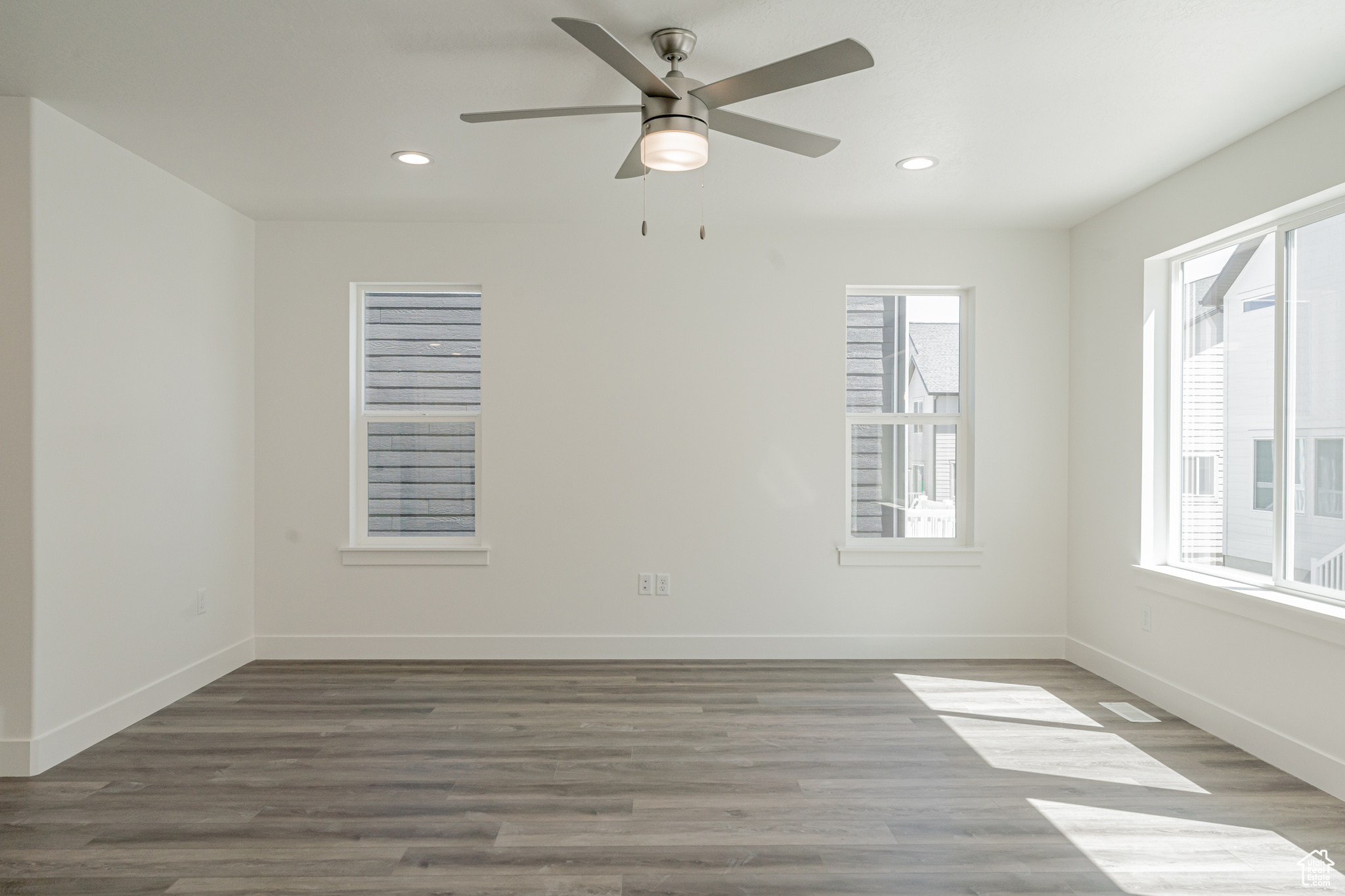 Empty room with hardwood / wood-style flooring and ceiling fan