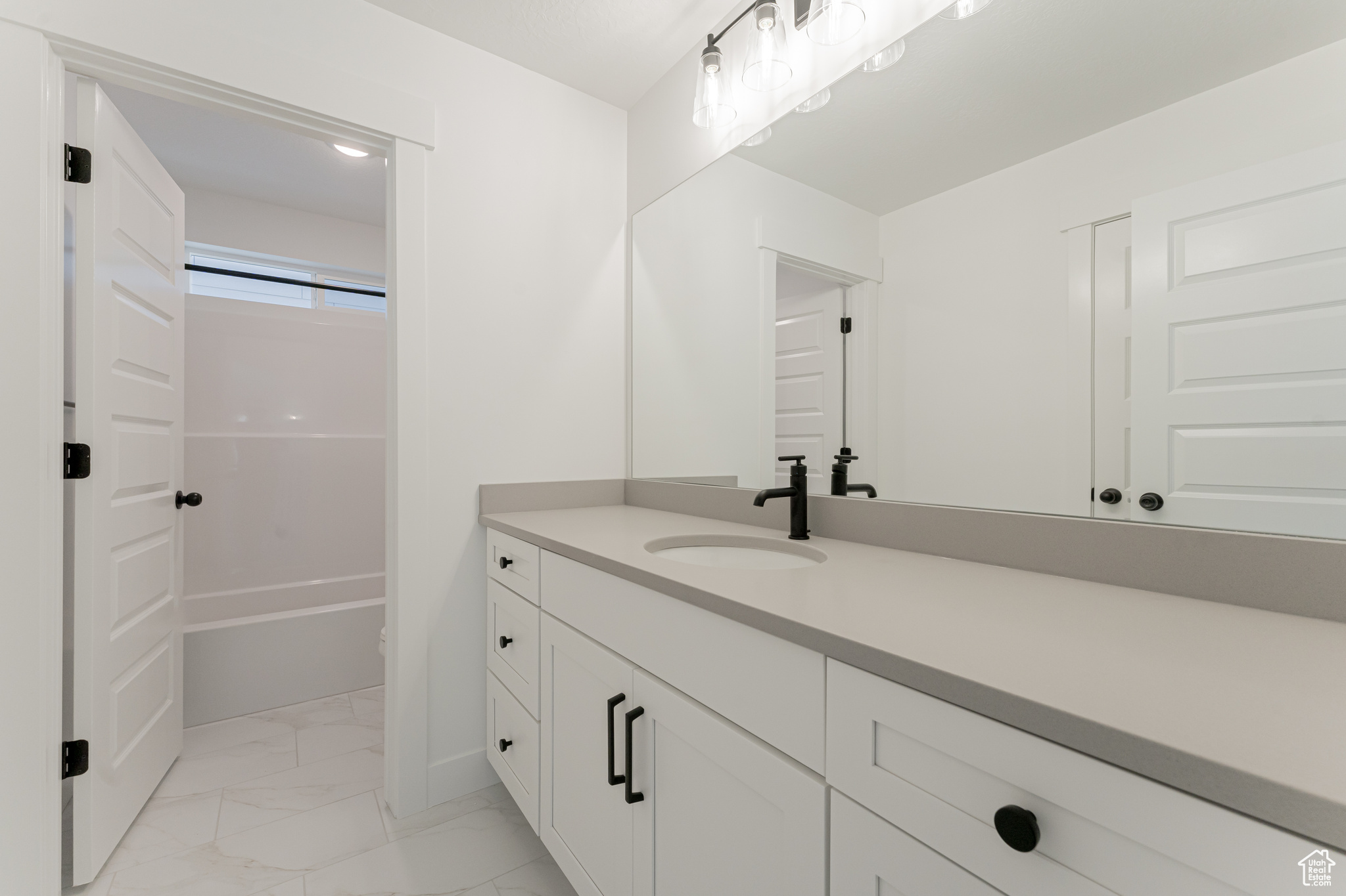 Bathroom with vanity and shower / bathing tub combination