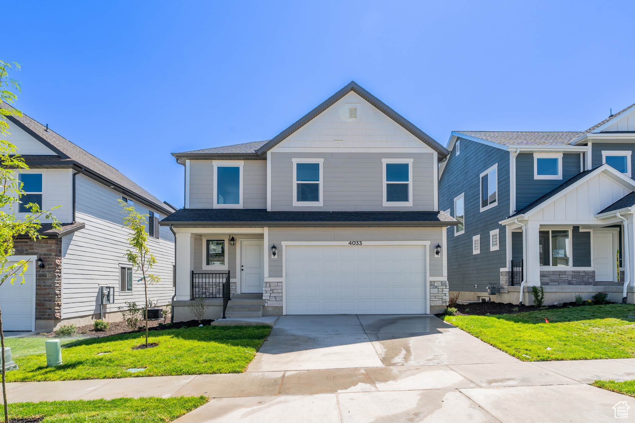 View of front of home with a garage and a front yard