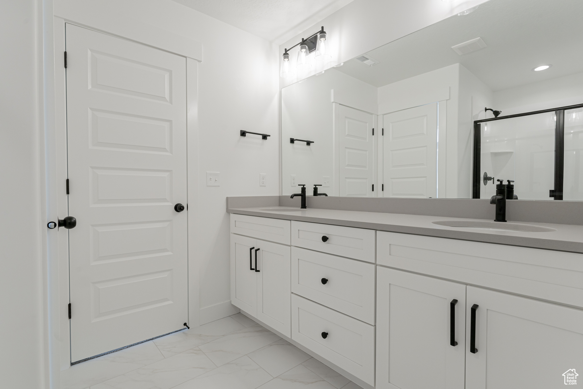 Bathroom featuring walk in shower and vanity