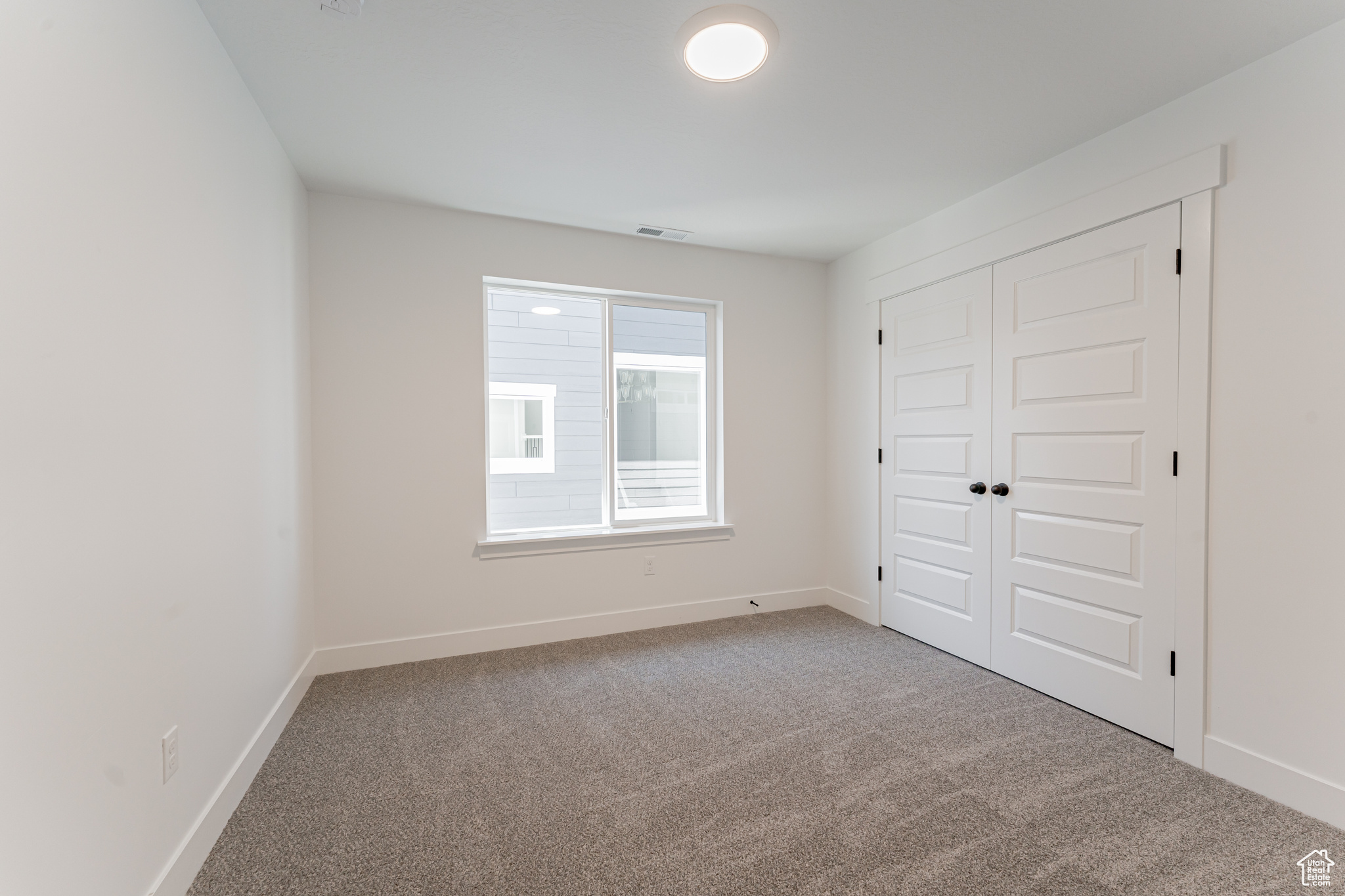 Unfurnished bedroom with a closet and carpet floors