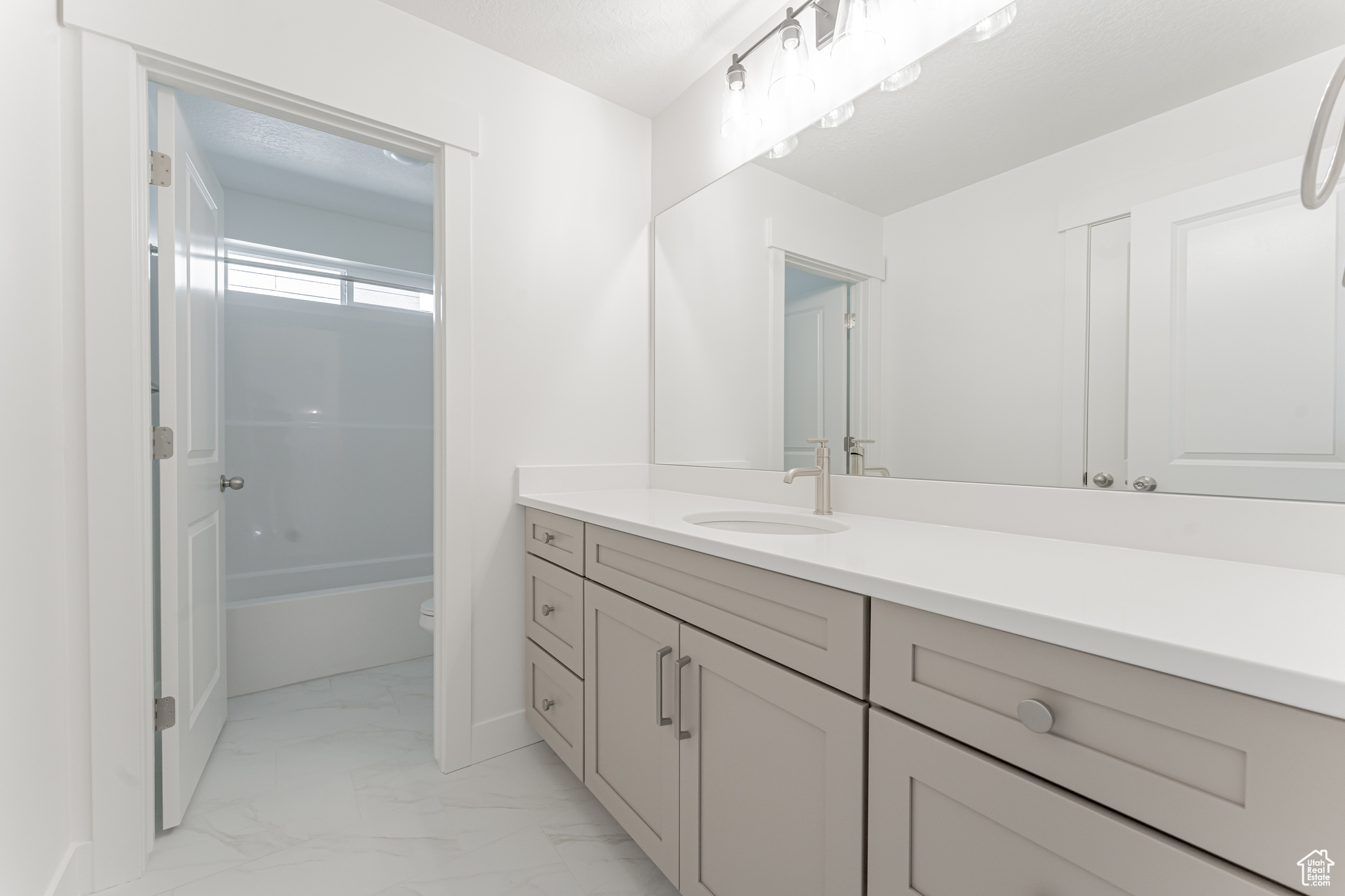 Full bathroom featuring tile patterned flooring, vanity, tub / shower combination, and toilet