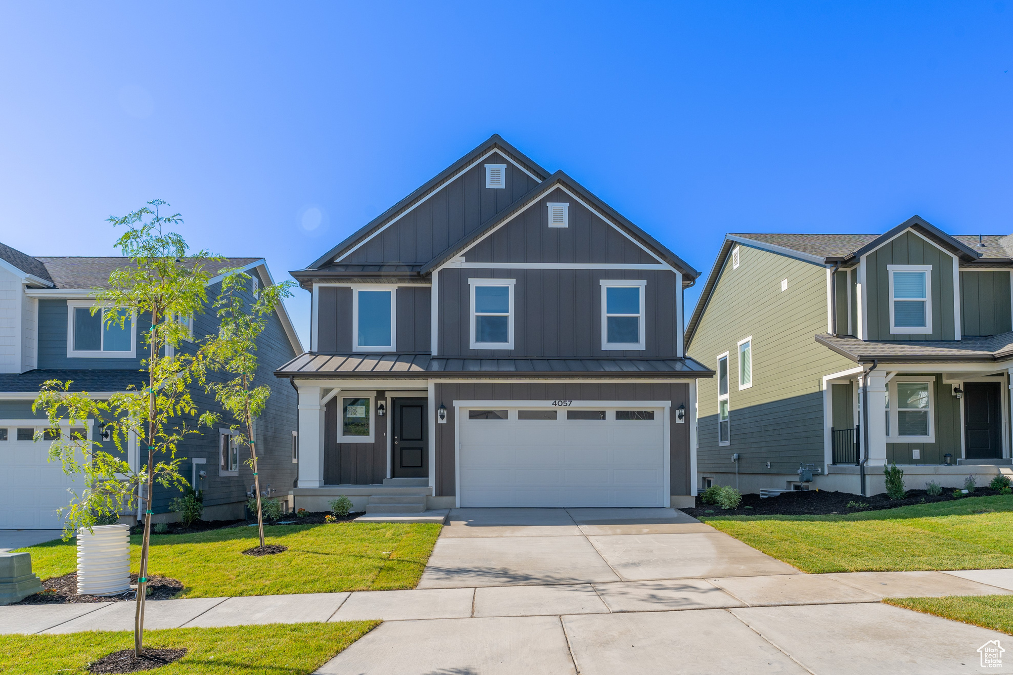 Craftsman-style home with a garage and a front lawn