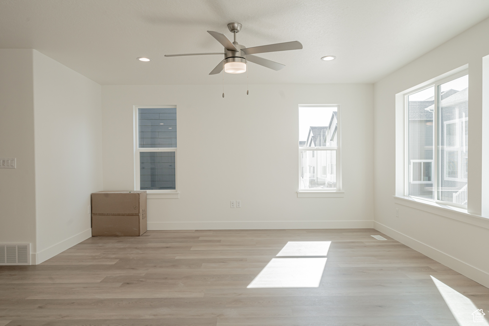 Spare room with ceiling fan and light wood-type flooring