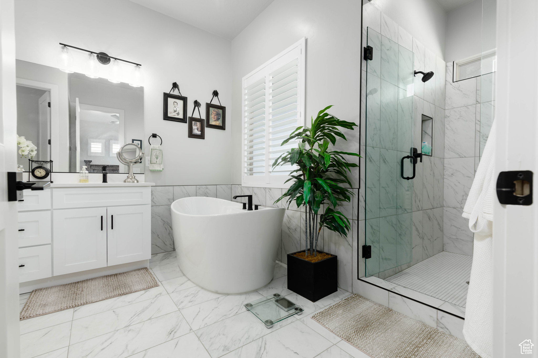 Bathroom with vanity, tile floors, tile walls, and plus walk in shower