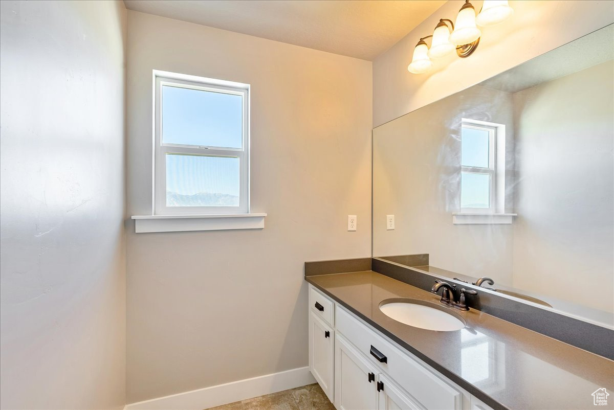 Bathroom featuring a wealth of natural light and vanity