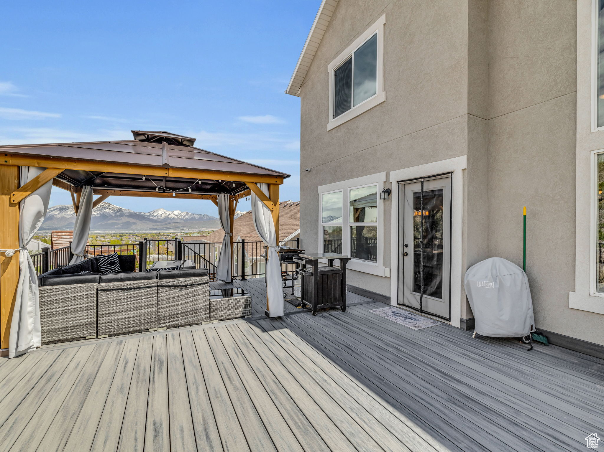 Deck with a mountain view, an outdoor living space, and a gazebo