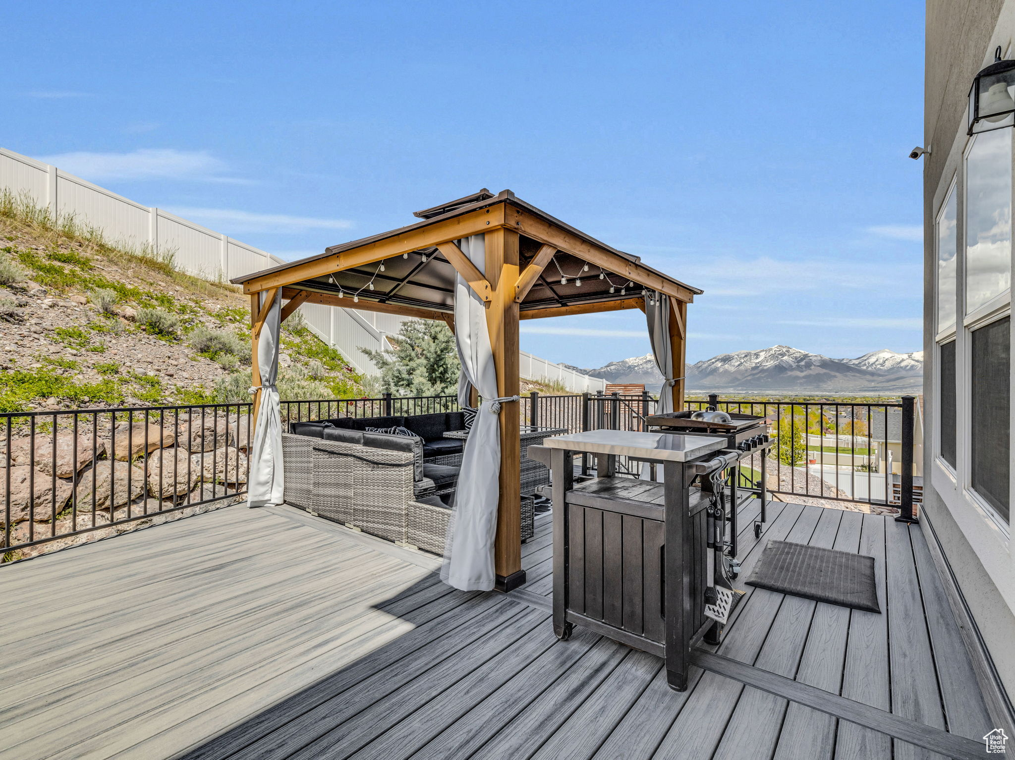 Wooden deck with a gazebo and a mountain view