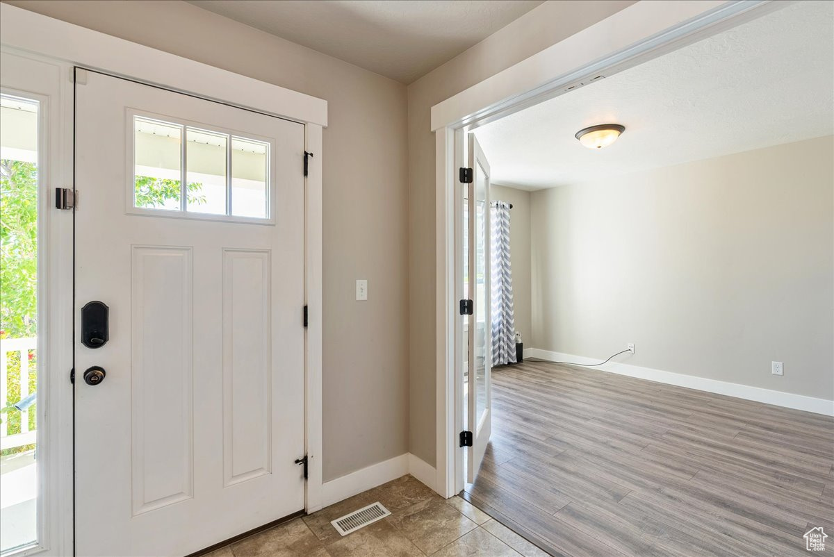 Foyer with light hardwood / wood-style flooring