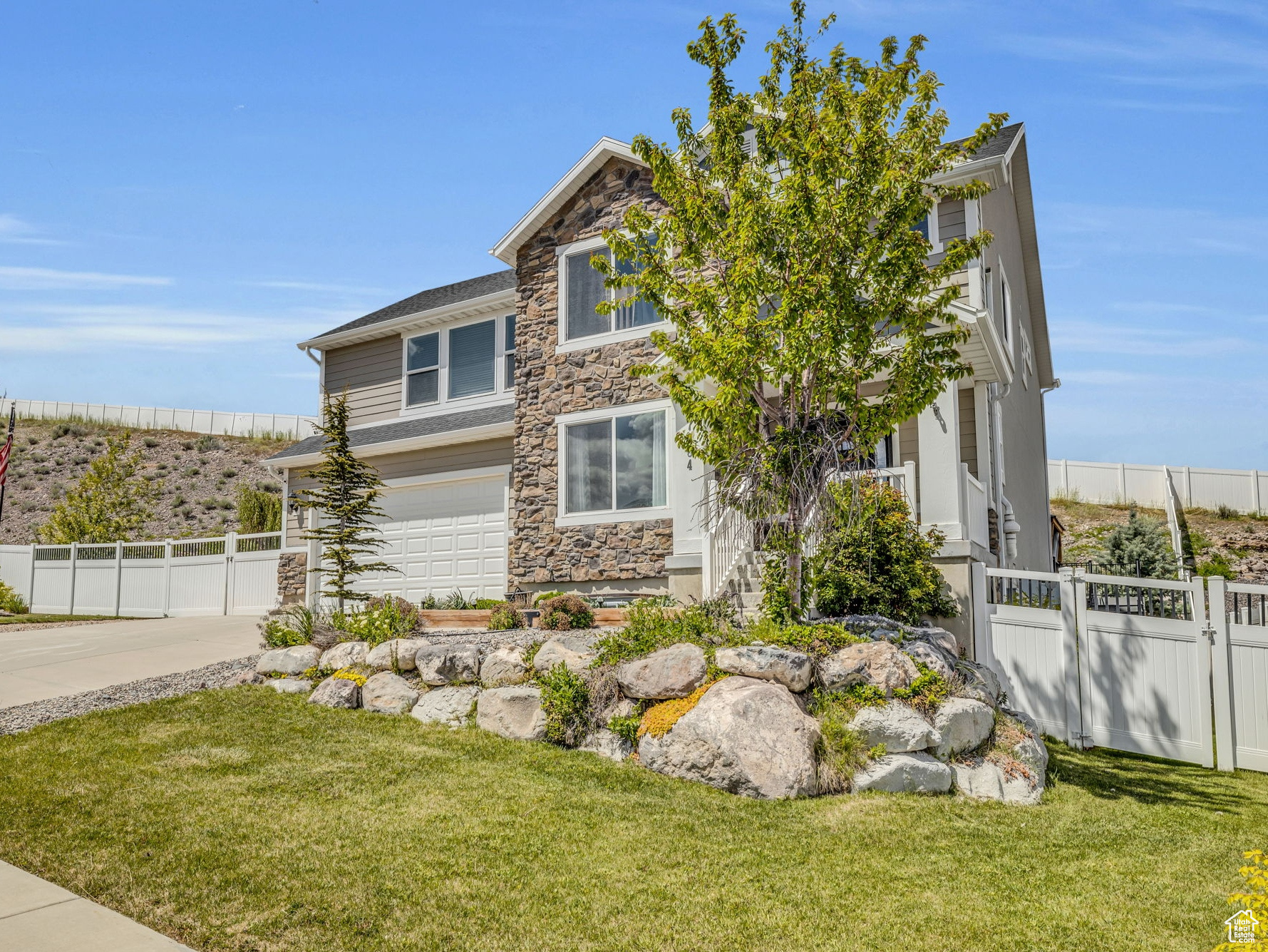 View of side of property with a garage and a yard