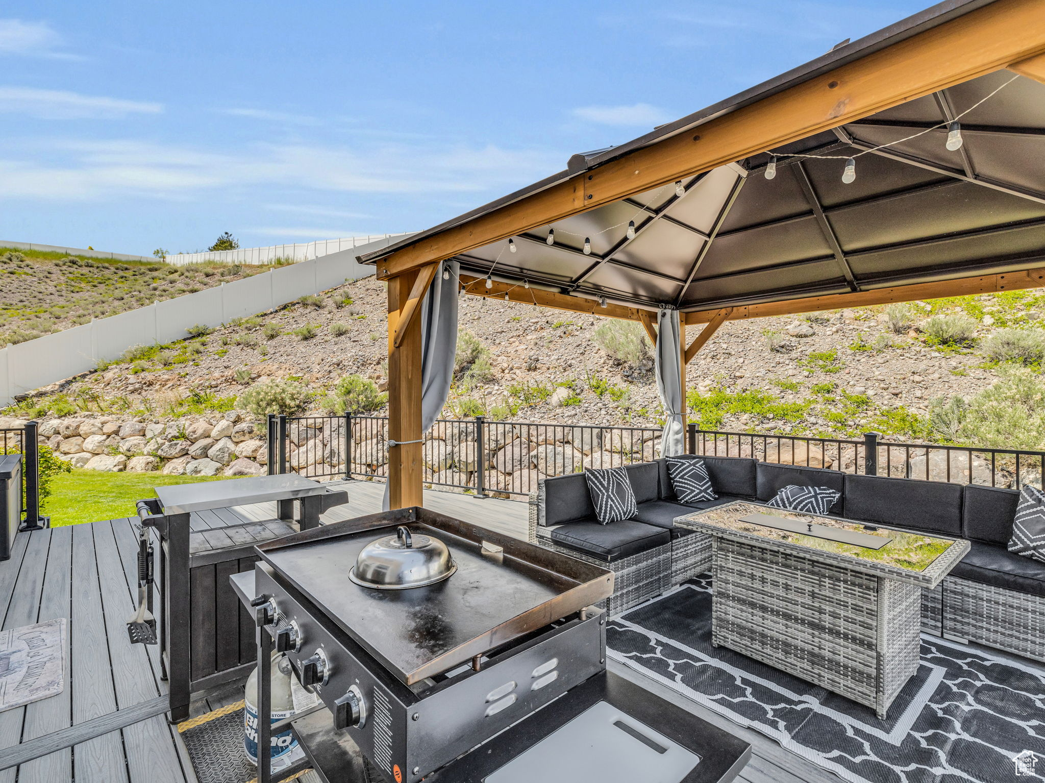 Deck featuring a gazebo and an outdoor living space