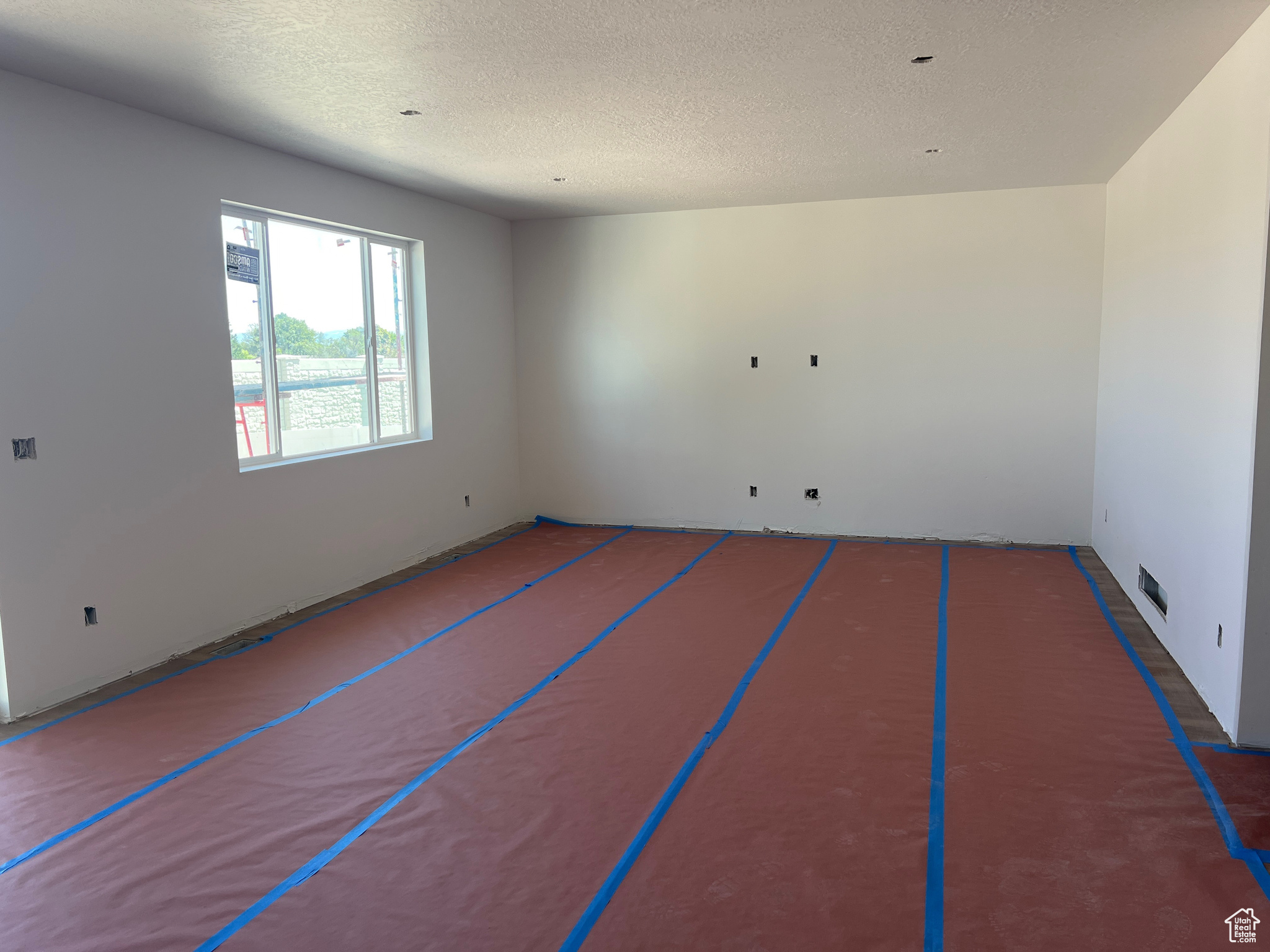 Empty room with a textured ceiling