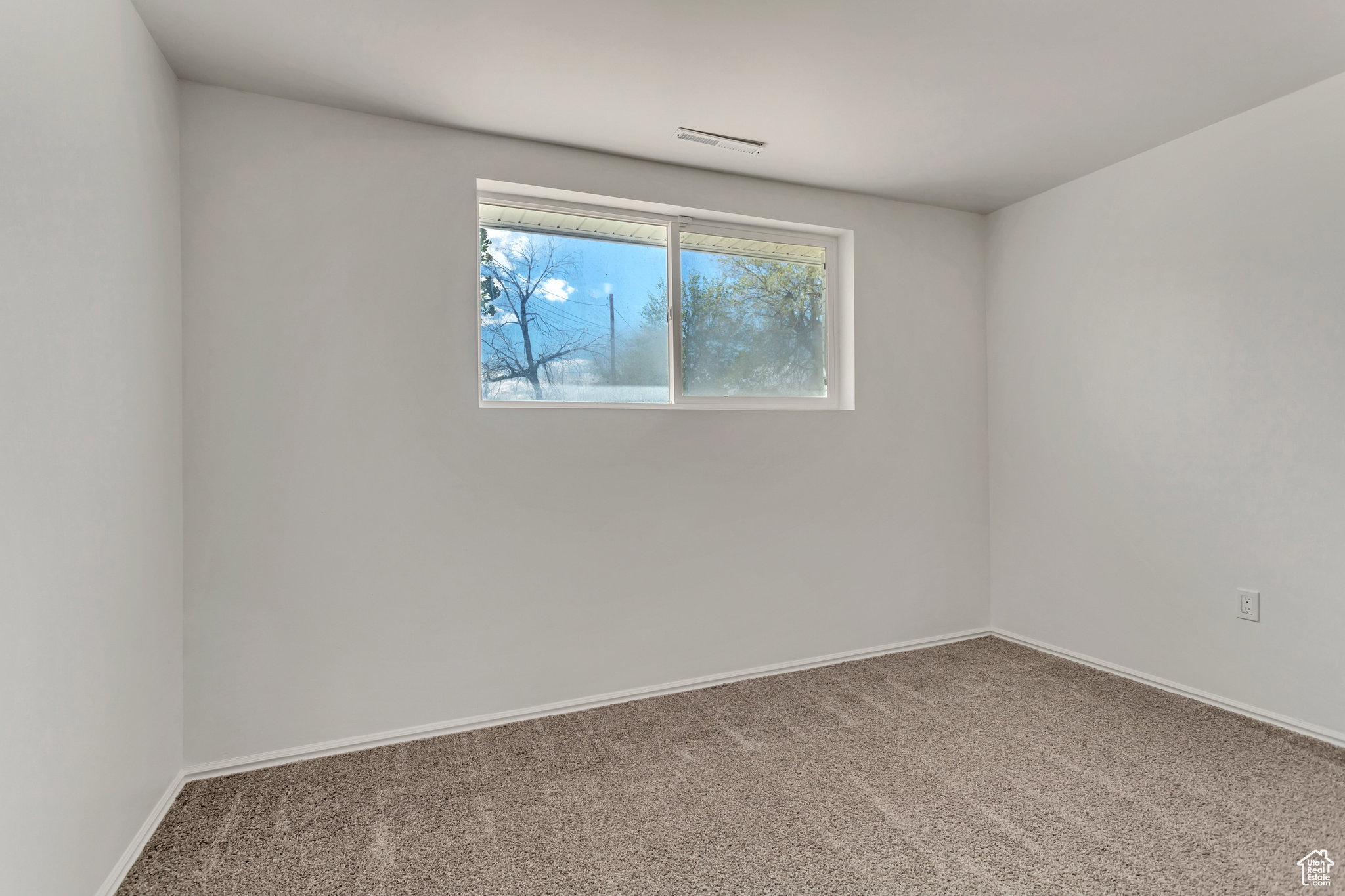 View of carpeted spare room