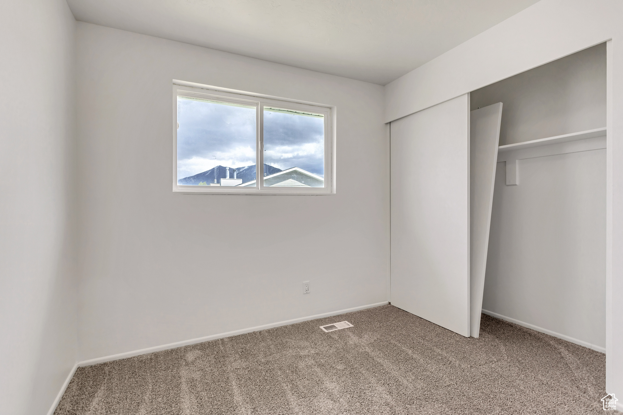 Unfurnished bedroom featuring a closet and carpet flooring