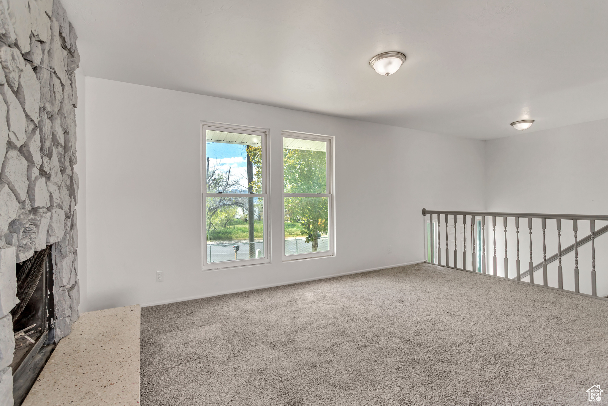 Interior space with carpet floors and a fireplace