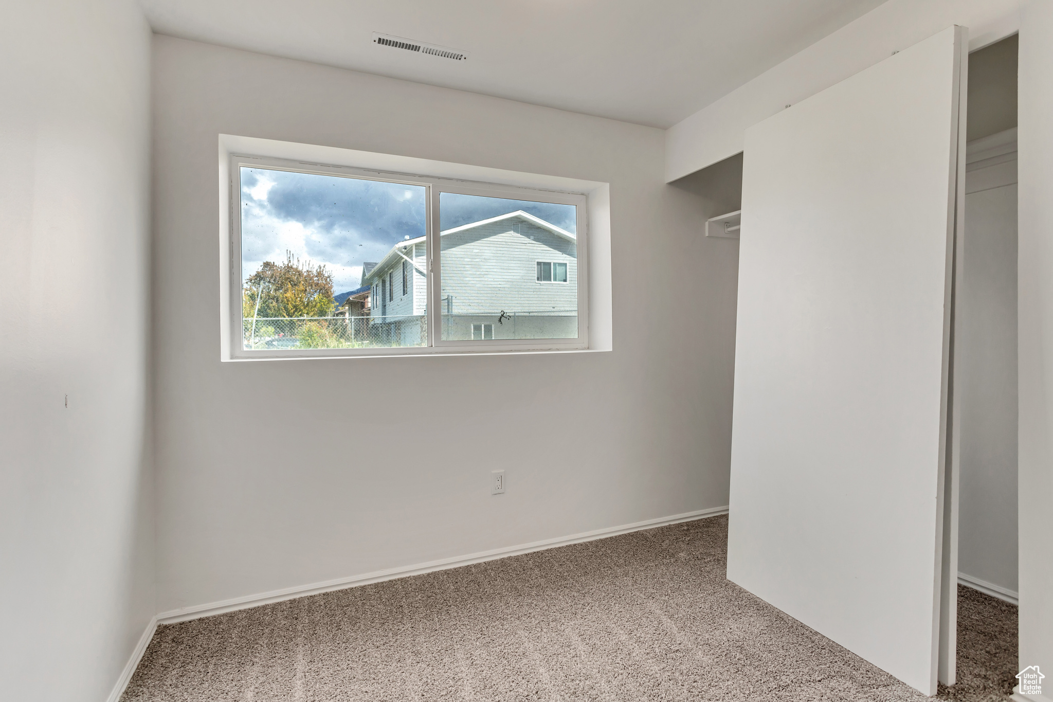 Unfurnished bedroom with carpet flooring and a closet