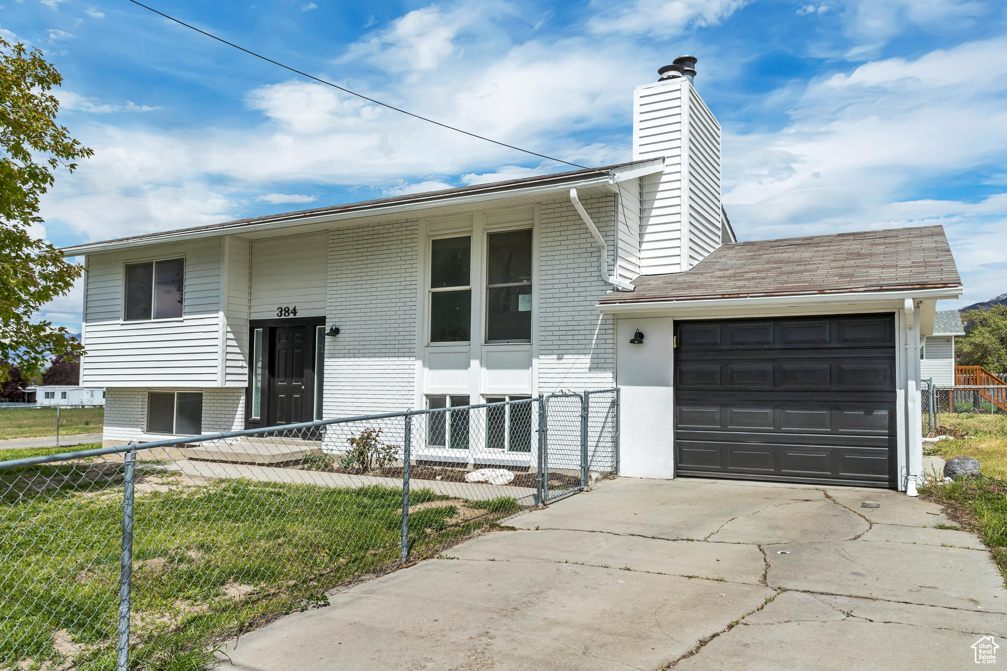 View of front facade with a garage and a front lawn