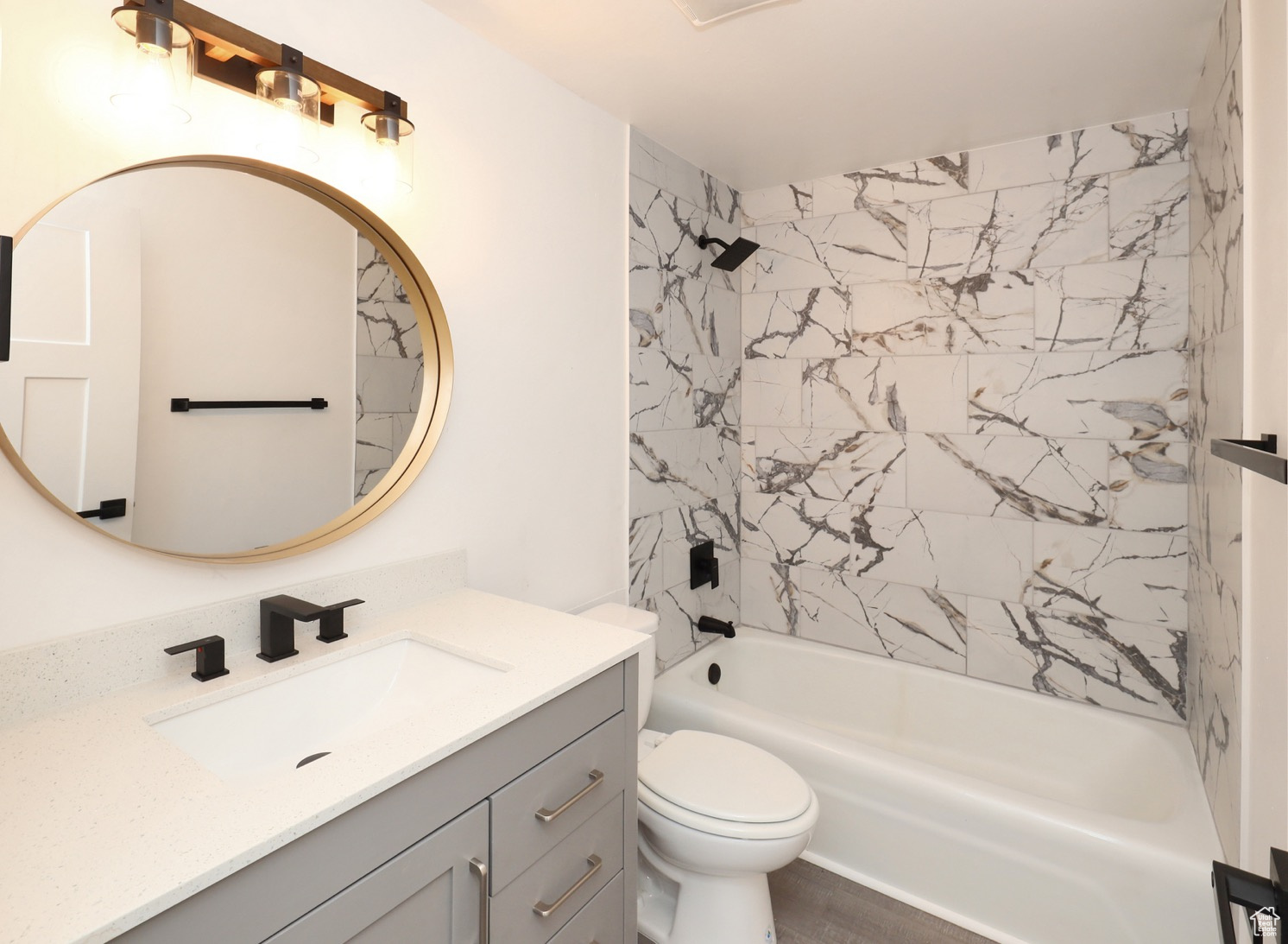 Full bathroom featuring tiled shower / bath, vanity, and toilet