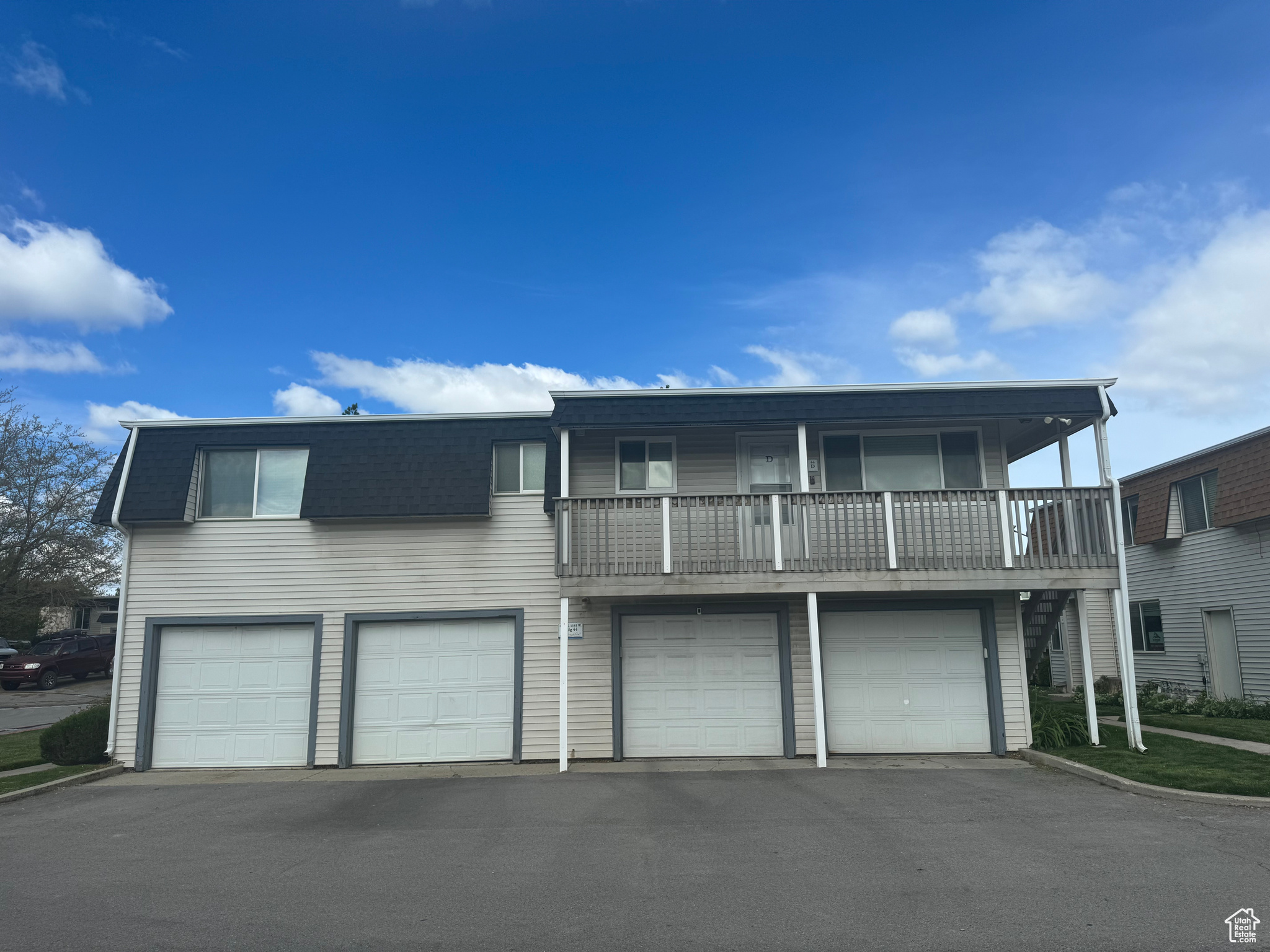 View of front property with a balcony and a garage