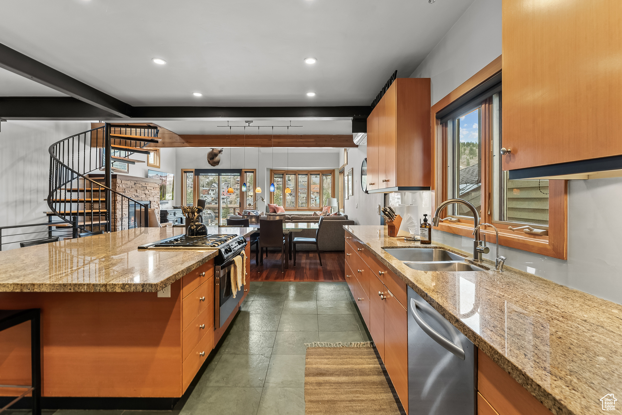 Kitchen with beam ceiling, sink, a wealth of natural light, and stainless steel appliances