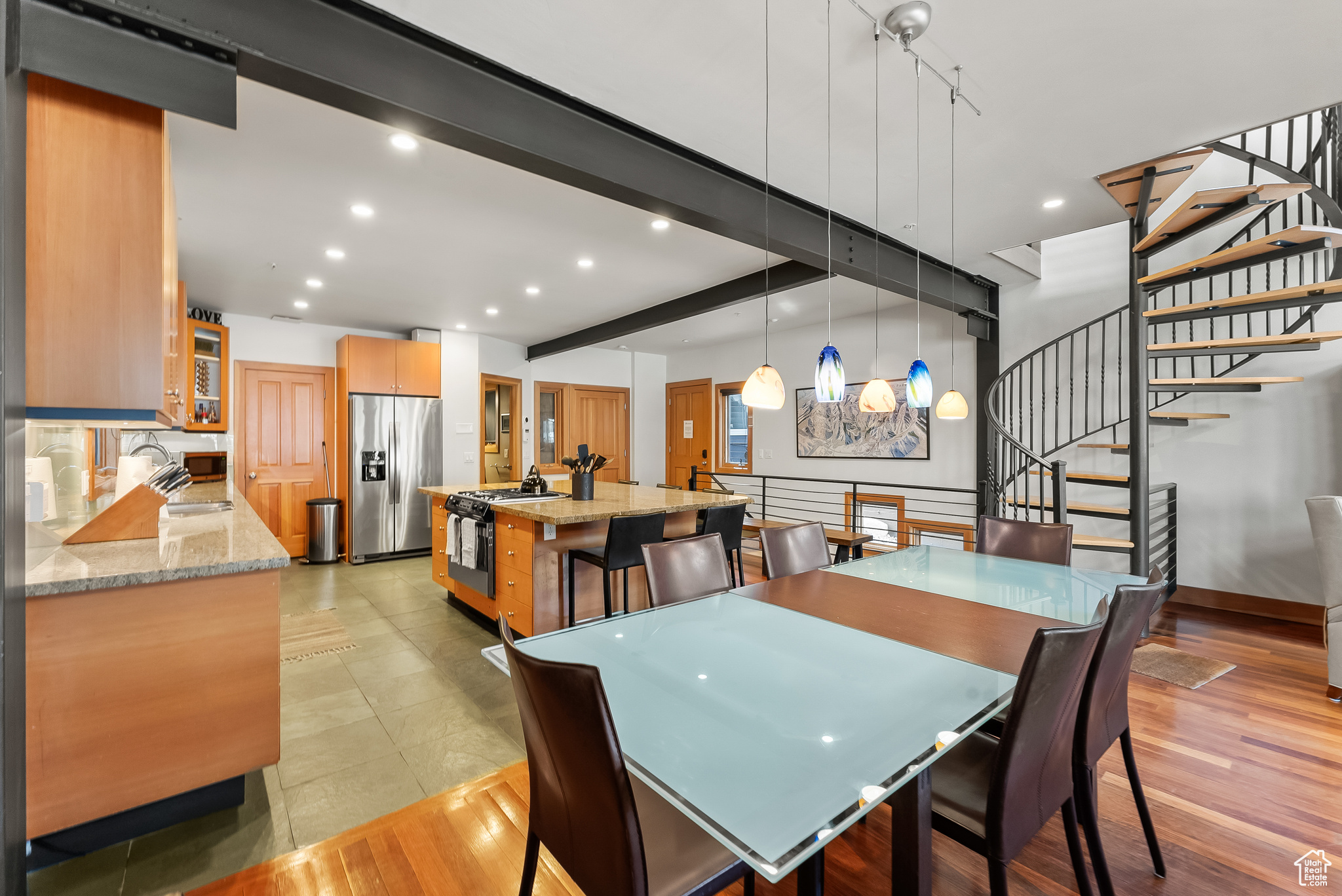 Dining area featuring beamed ceiling, sink, and light wood-type flooring