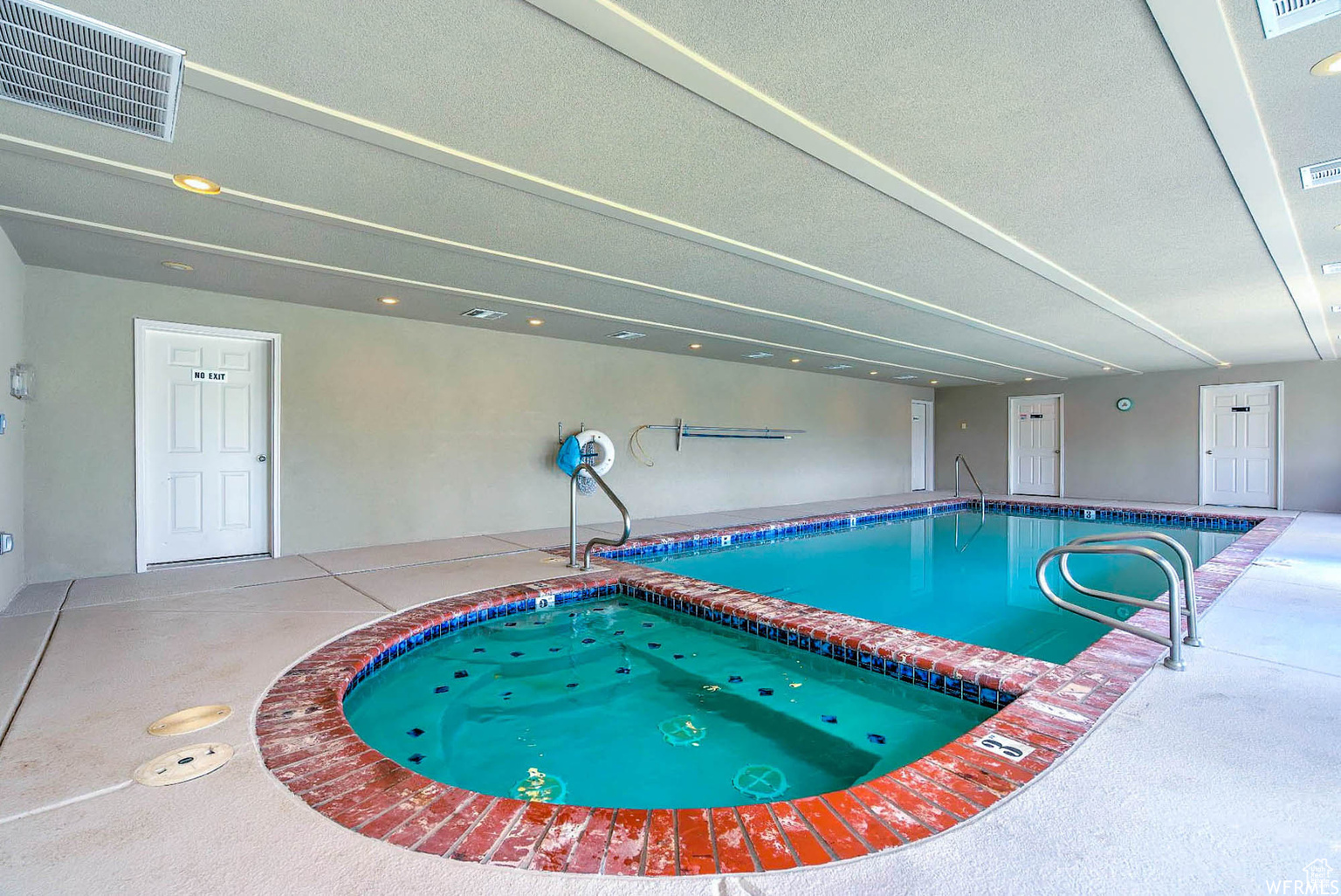 View of swimming pool featuring an indoor in ground hot tub