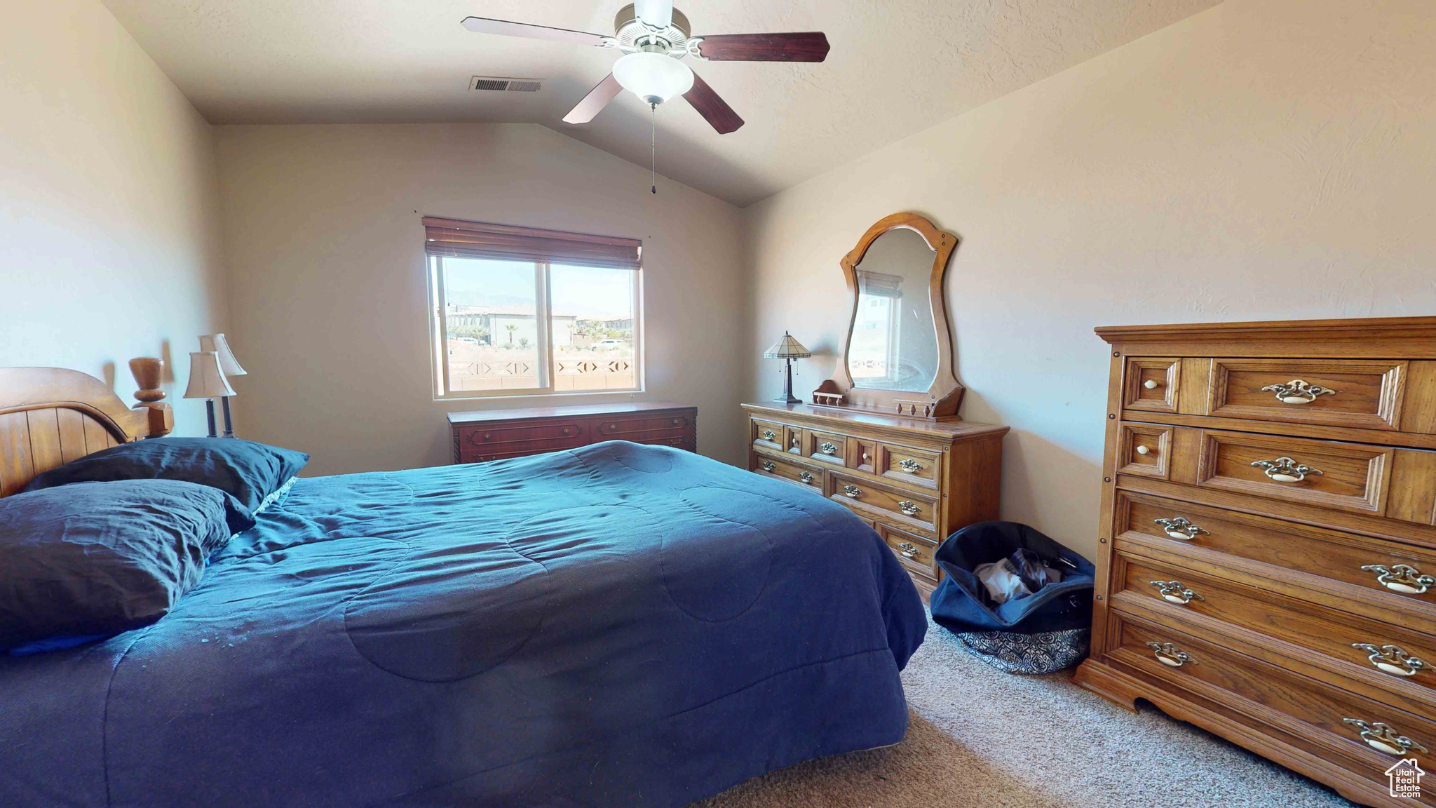 Bedroom featuring carpet flooring, lofted ceiling, and ceiling fan