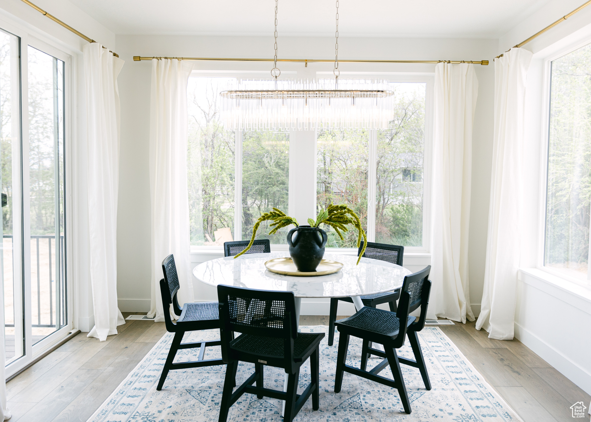 Dining space with plenty of natural light and light hardwood / wood-style floors
