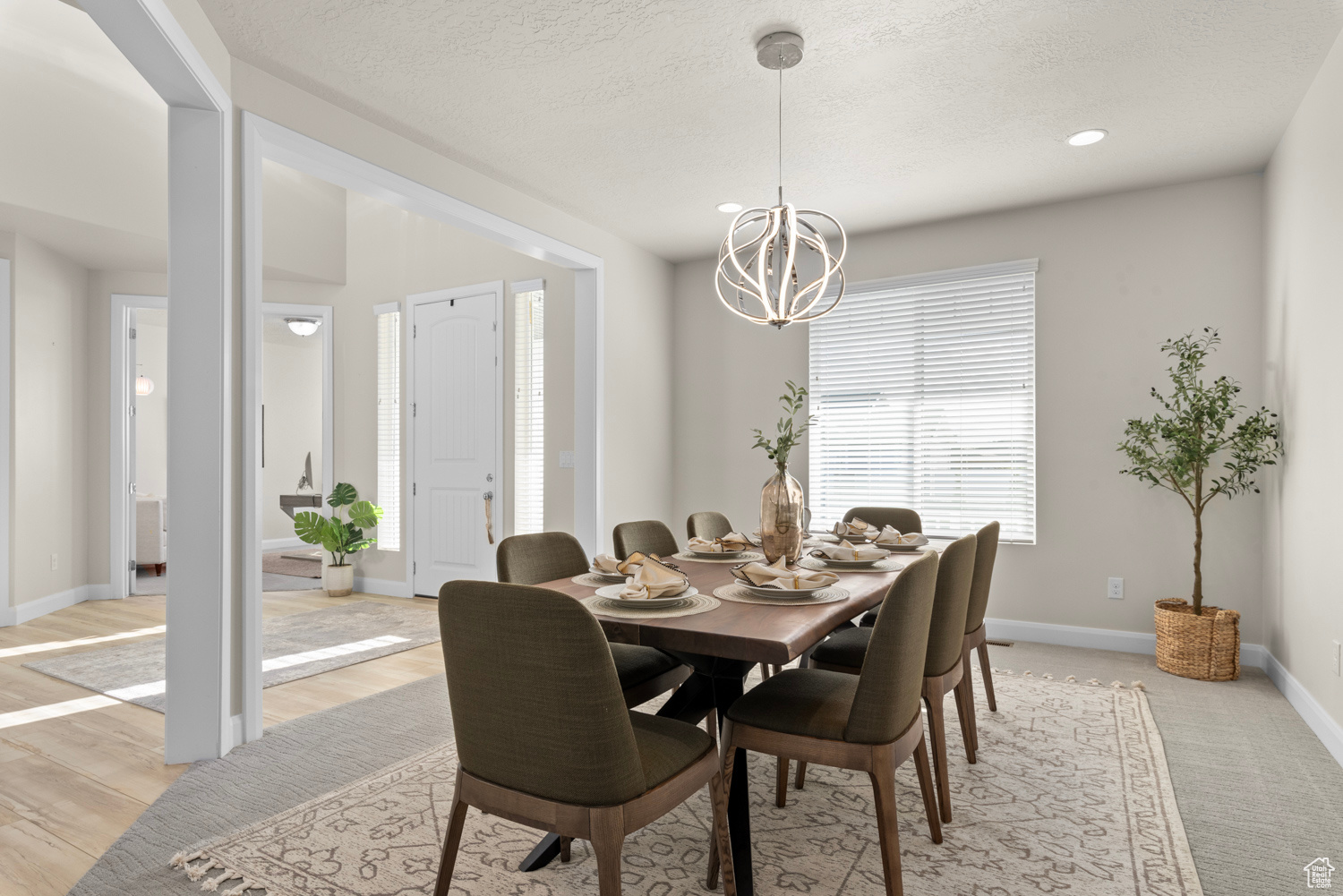 Formal dining room with new LED chandelier, plenty of natural light, brand new carpet