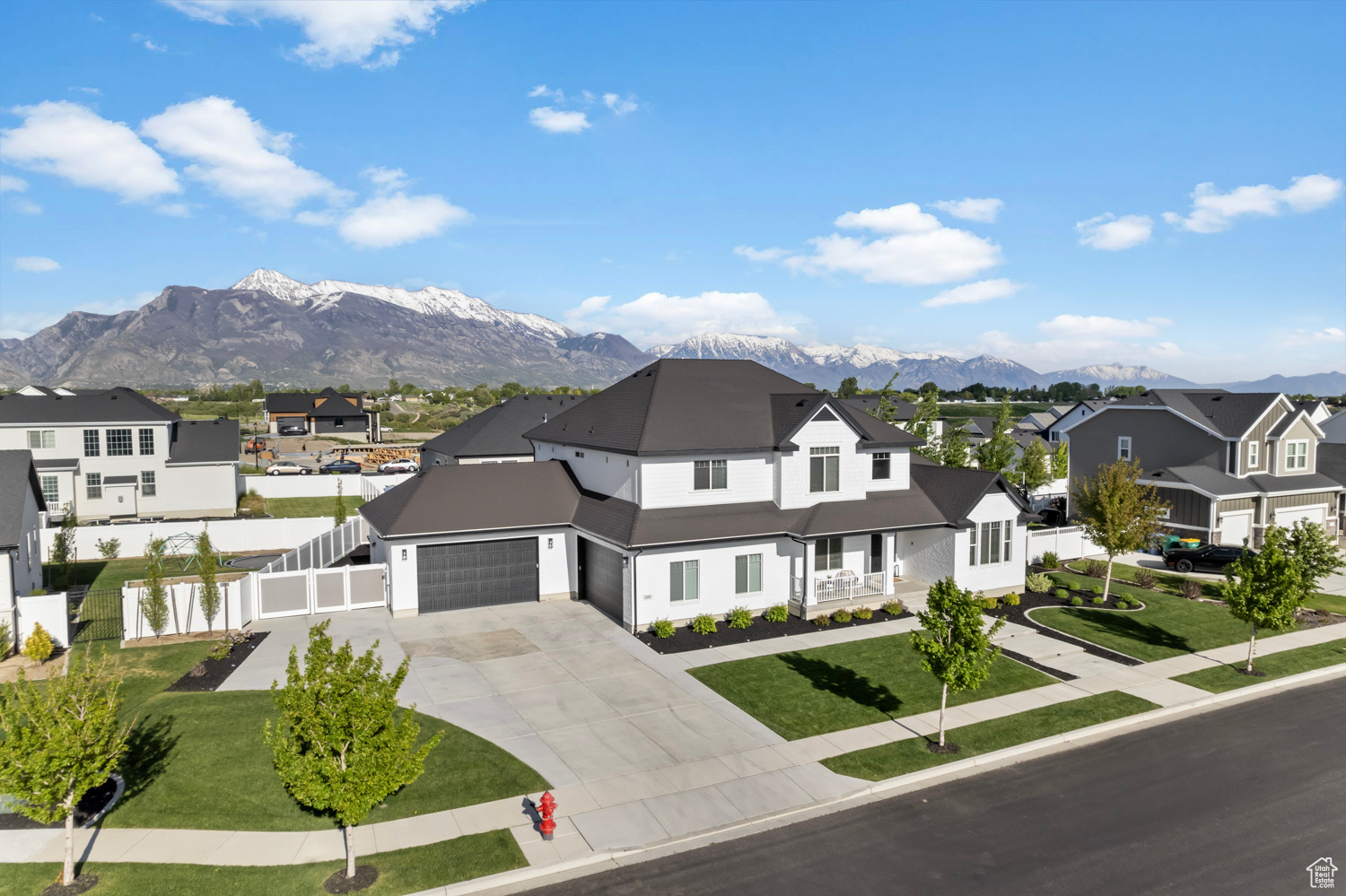 View of front facade looking to the southeast featuring 4 car garage,Rv/Boat parking, mountain views, and front lawn