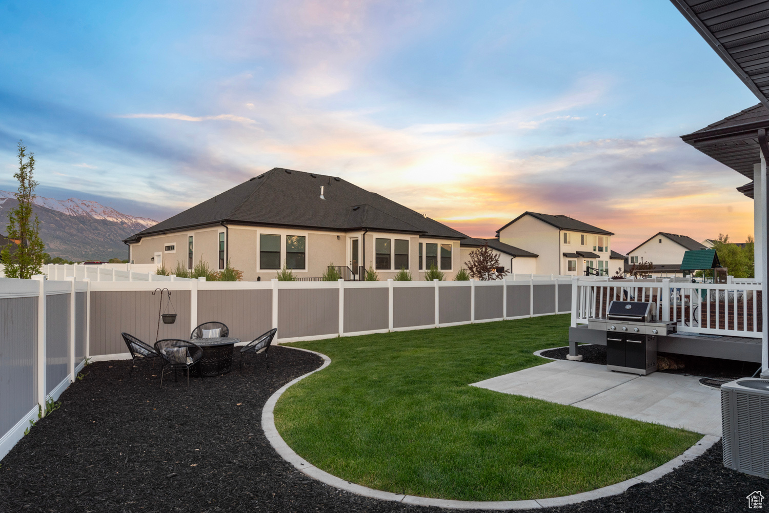 View of yard at dusk, looking southeast, firepit area (firepit excluded), fully fenced