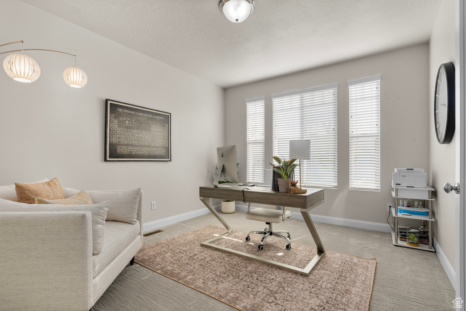 Office space with a textured ceiling and brand new carpet