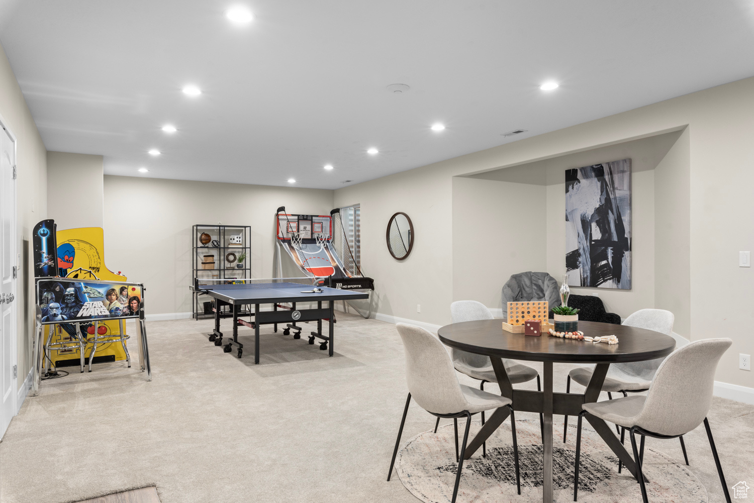 Spacious game room area with wet bar hookups, 2 large finished storage closets