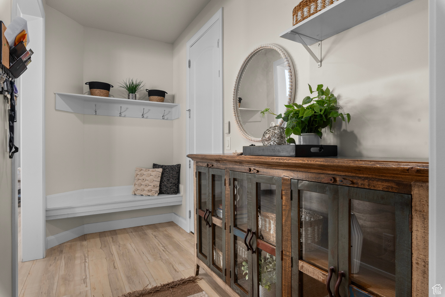 Mudroom featuring built-in bench and shelving