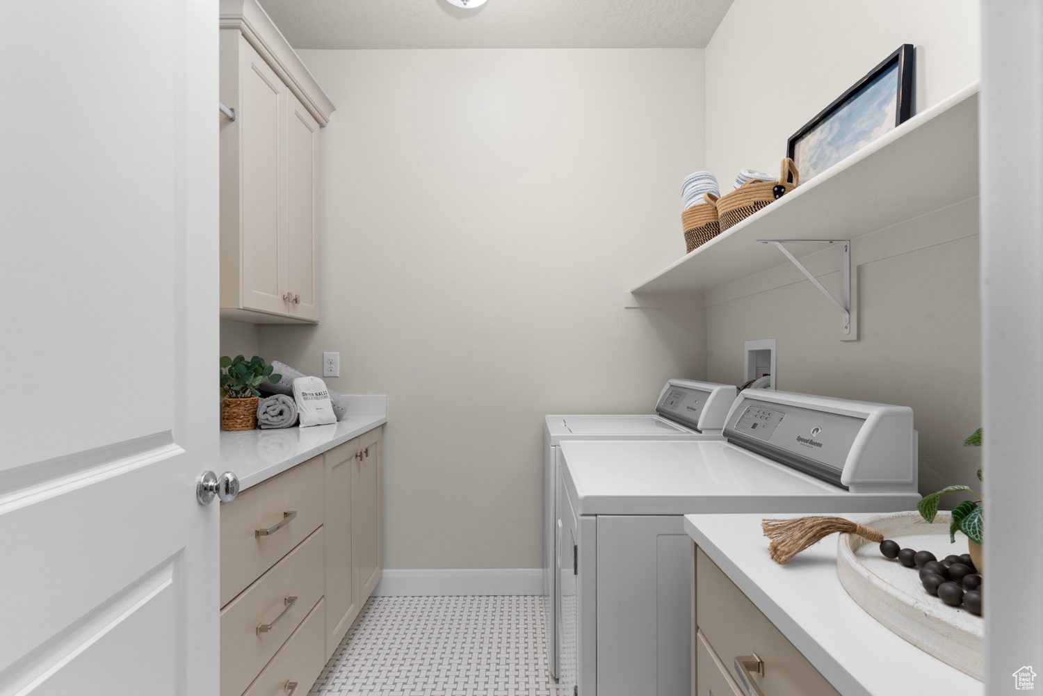 Laundry room featuring cabinets, gas dryer hookup, light tile flooring, washer and dryer included