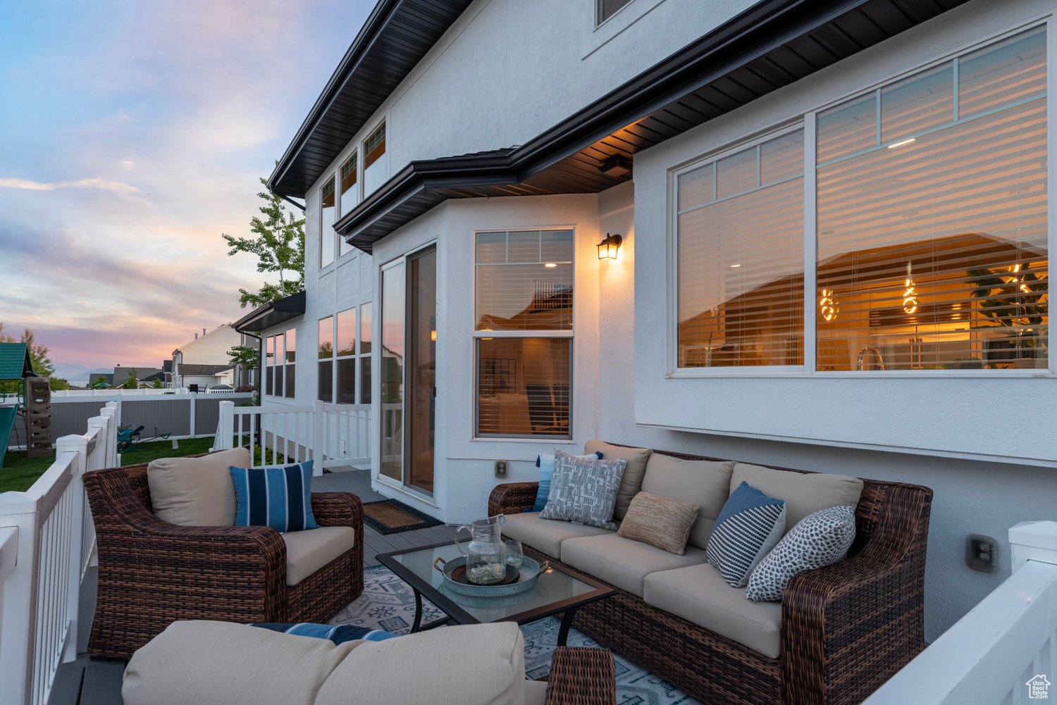 Back deck at dusk with an outdoor living space