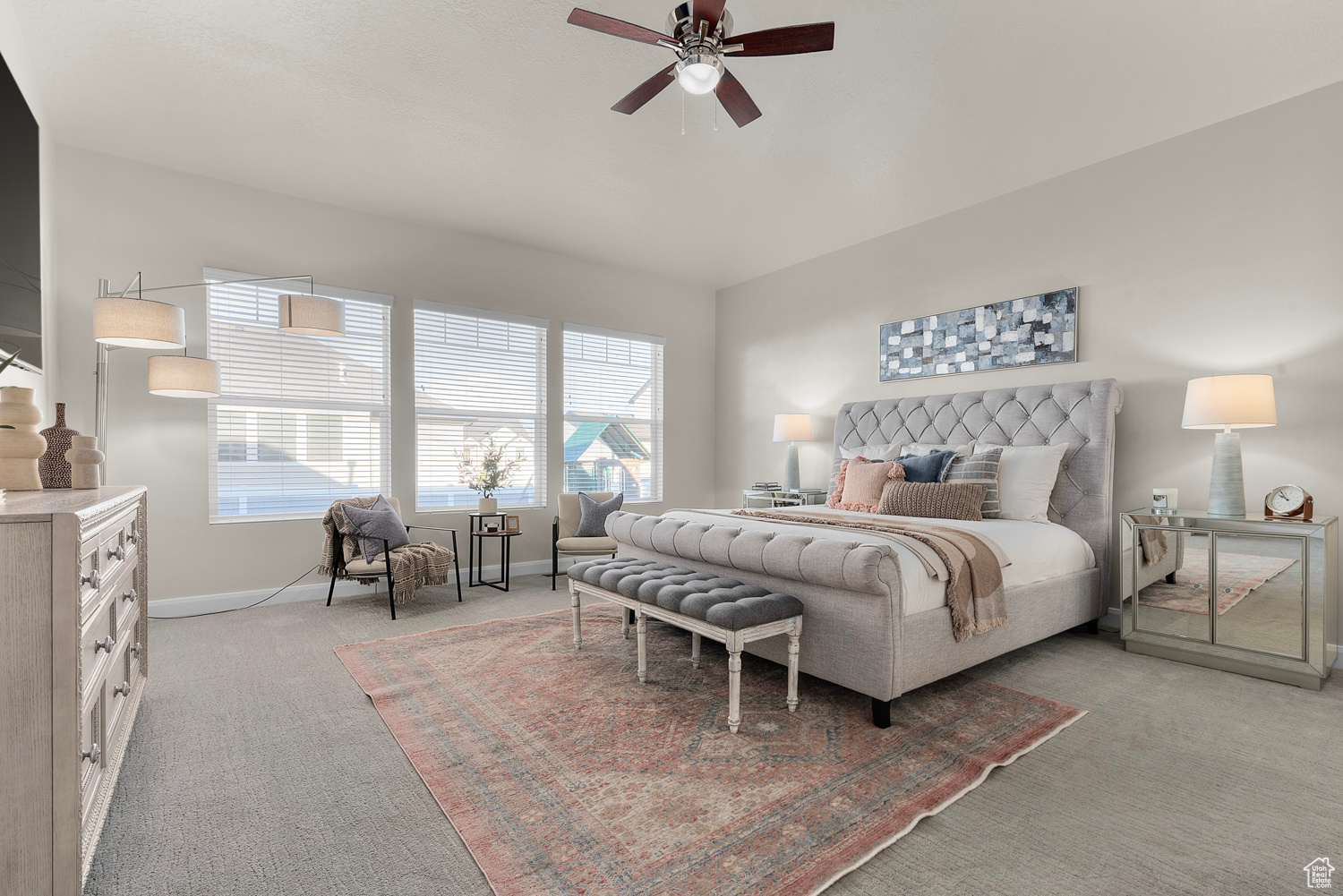 Primary bedroom with brand new carpet, ceiling fan, TV included