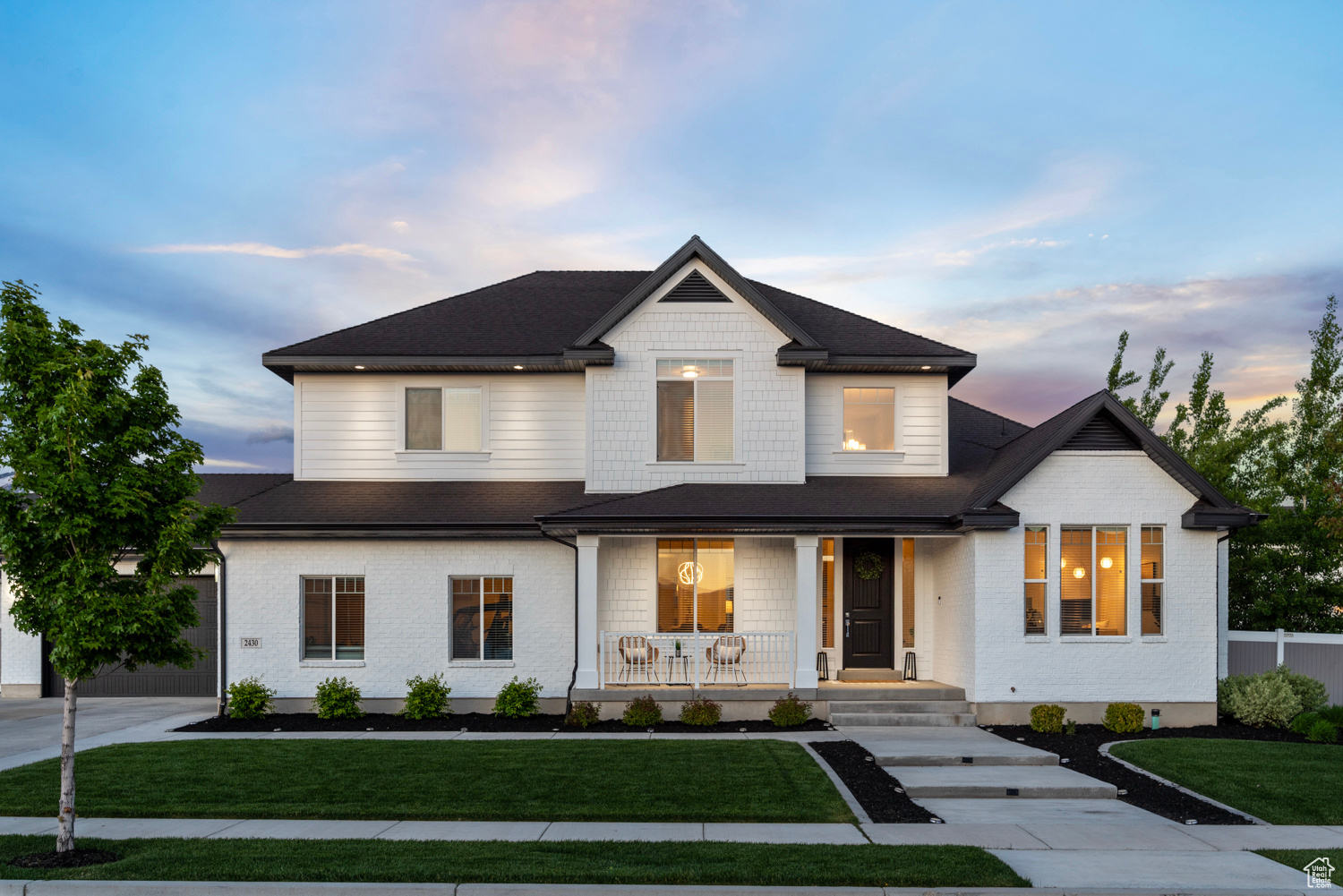 West facing property, spacious front porch, outdoor lighting, and a 4 car garage