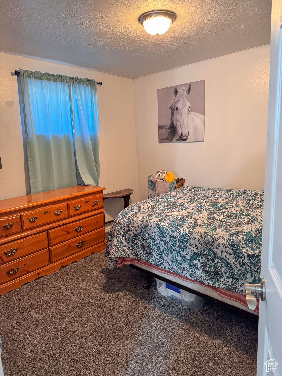 Bedroom with carpet and a textured ceiling