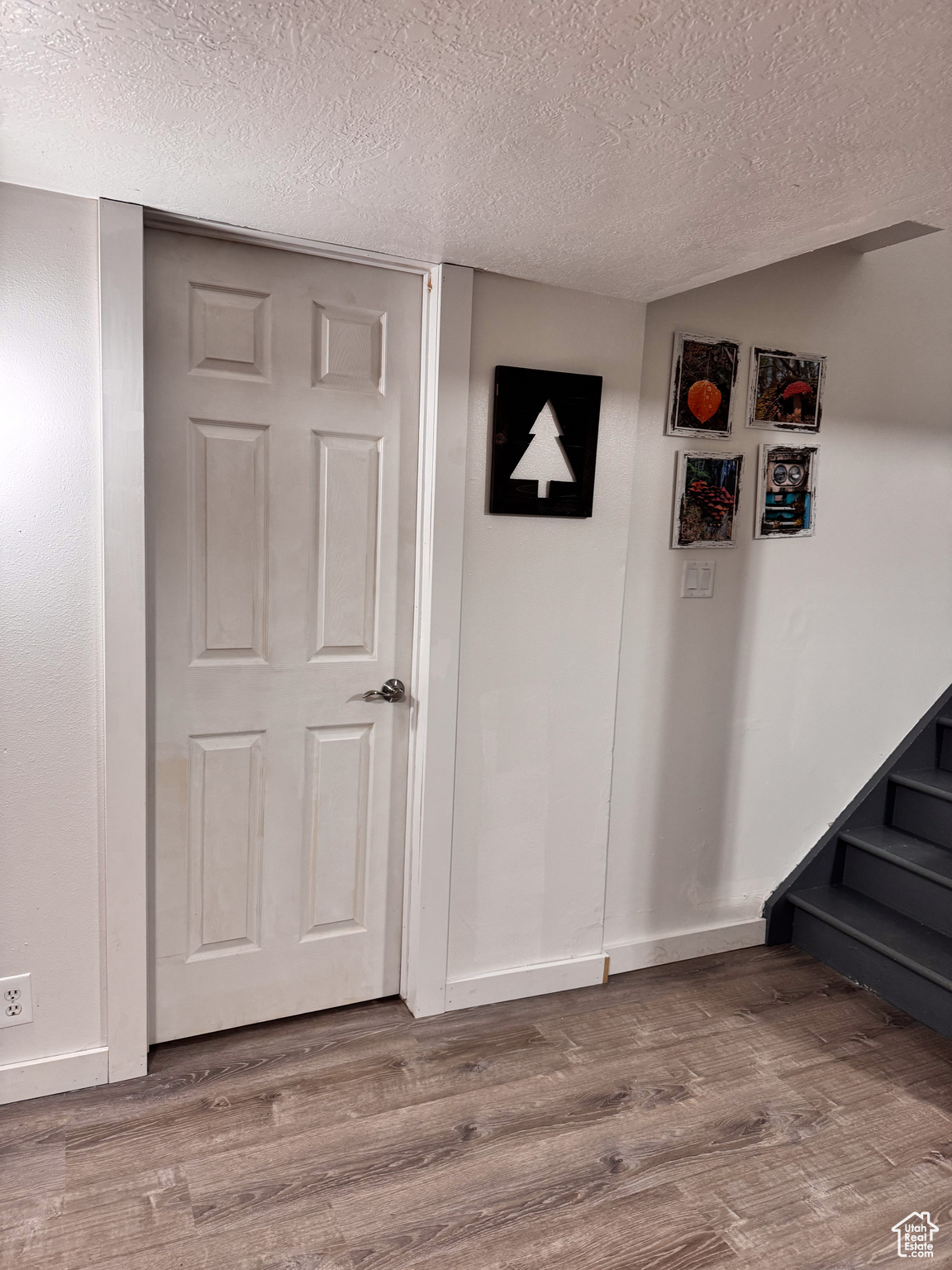 Interior space with hardwood / wood-style flooring and a textured ceiling