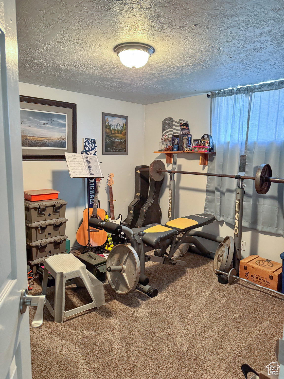 Workout room featuring carpet and a textured ceiling