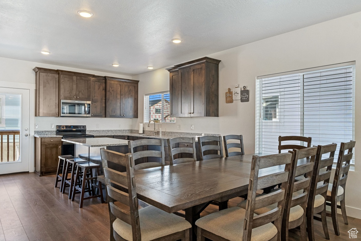 Dining area with dark hardwood / wood-style floors