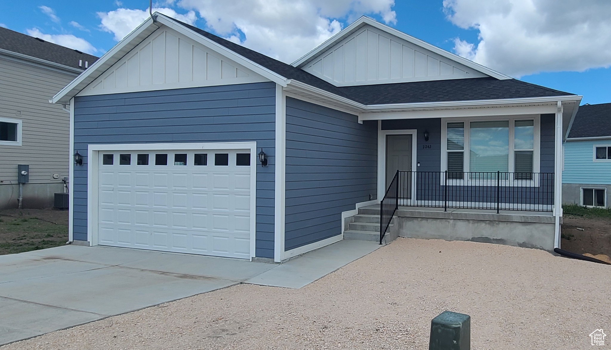 View of front of house featuring covered porch and a garage