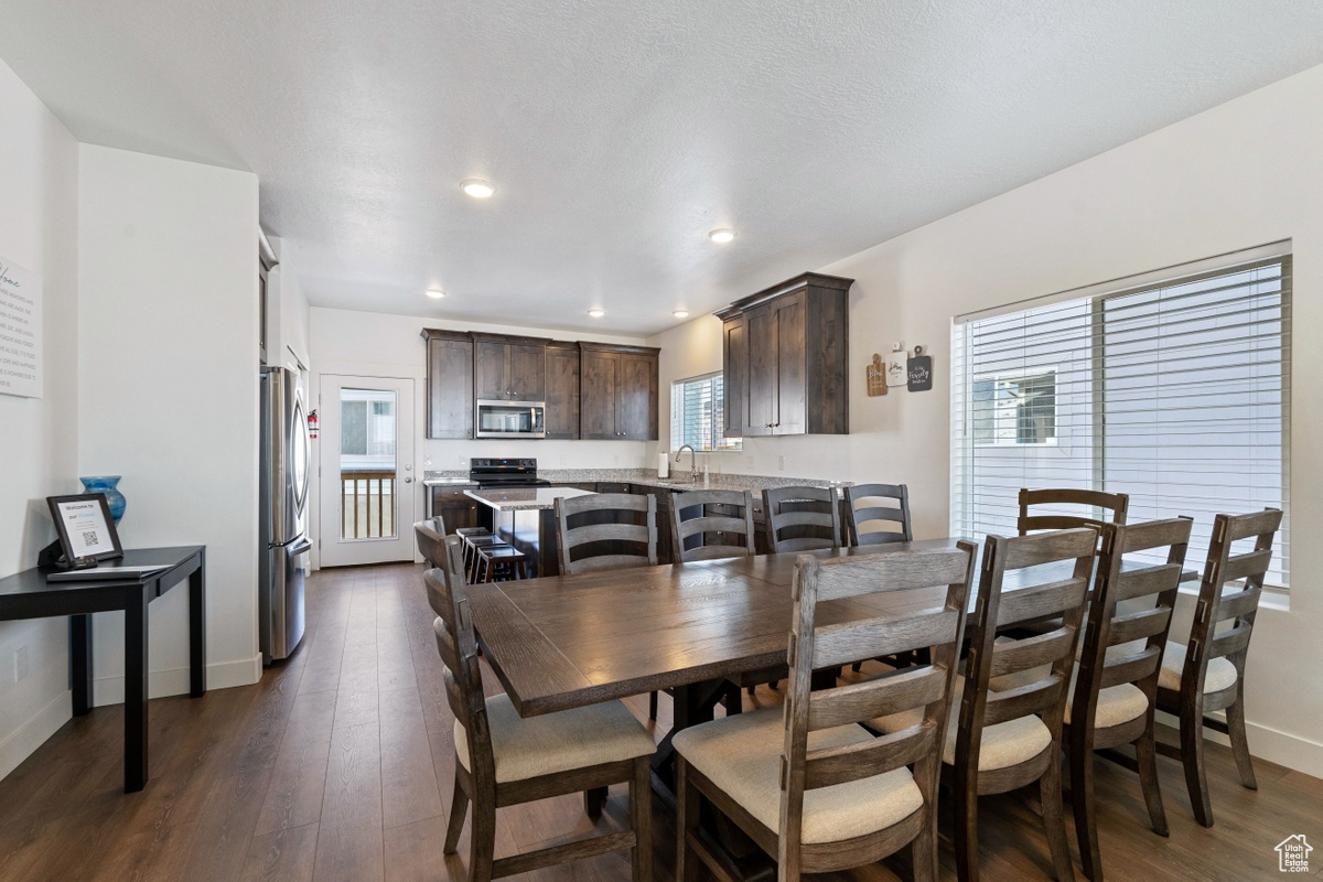 Dining area featuring sink and dark hardwood / wood-style flooring