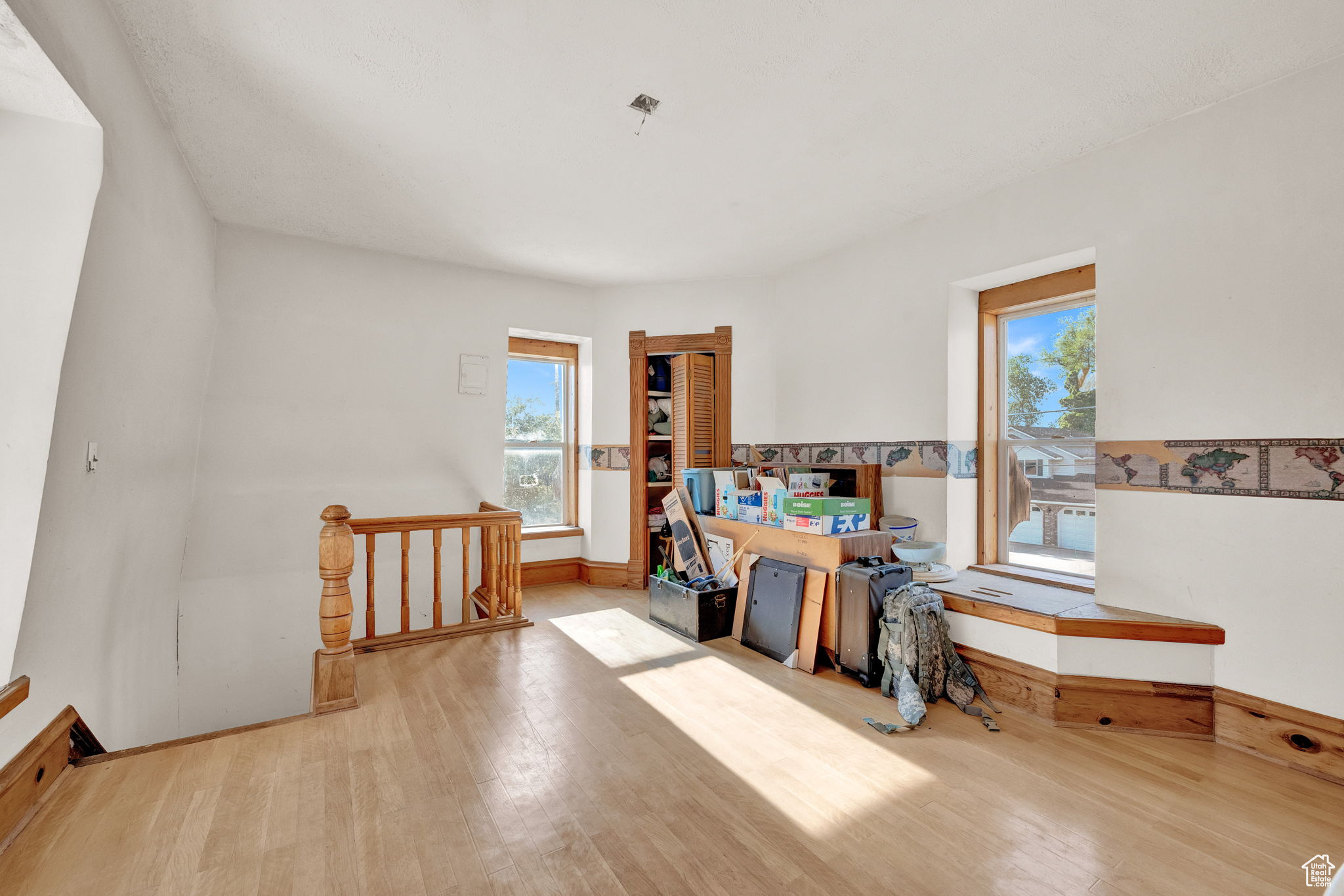 Miscellaneous room with a wealth of natural light and light hardwood / wood-style flooring