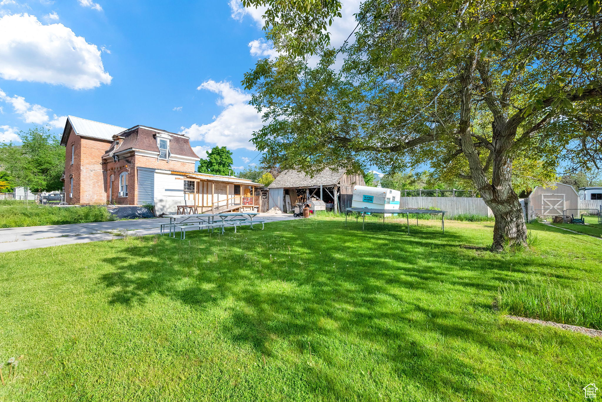 View of back of home with a outdoor structure