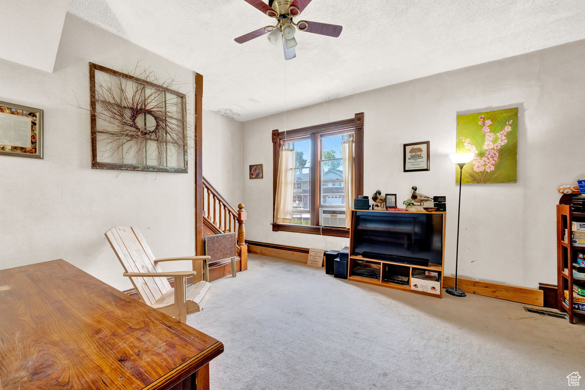 Sitting room with a baseboard heating unit, a textured ceiling, carpet floors, and ceiling fan