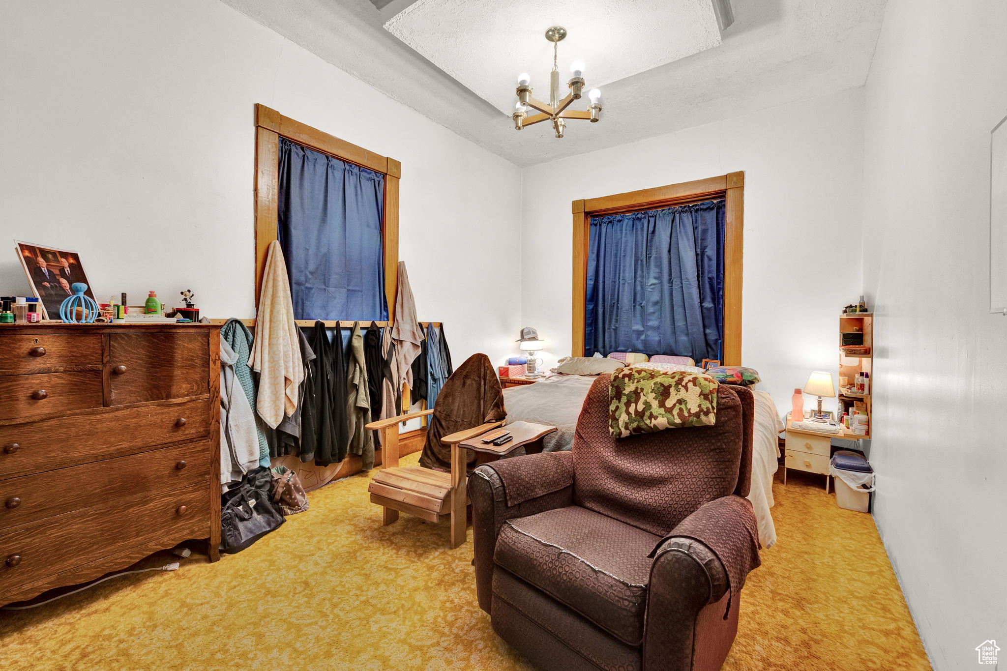 Bedroom featuring a chandelier and carpet