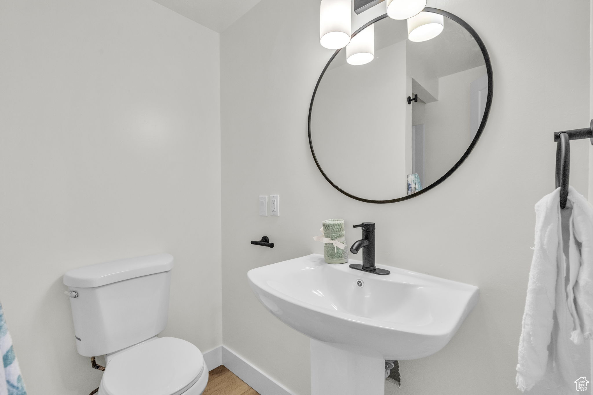 Bathroom with sink, hardwood / wood-style flooring, and toilet